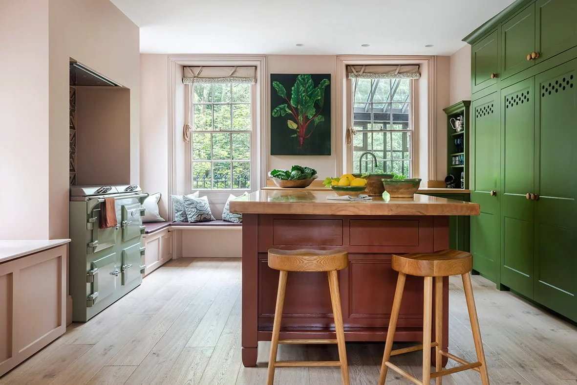 Pale pink walls and bancha green cupboards in farmhouse kitchen with Everhot in Georgian Villa in Jersey