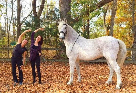 Ann Swanson with professional rider Kathy and a white horse