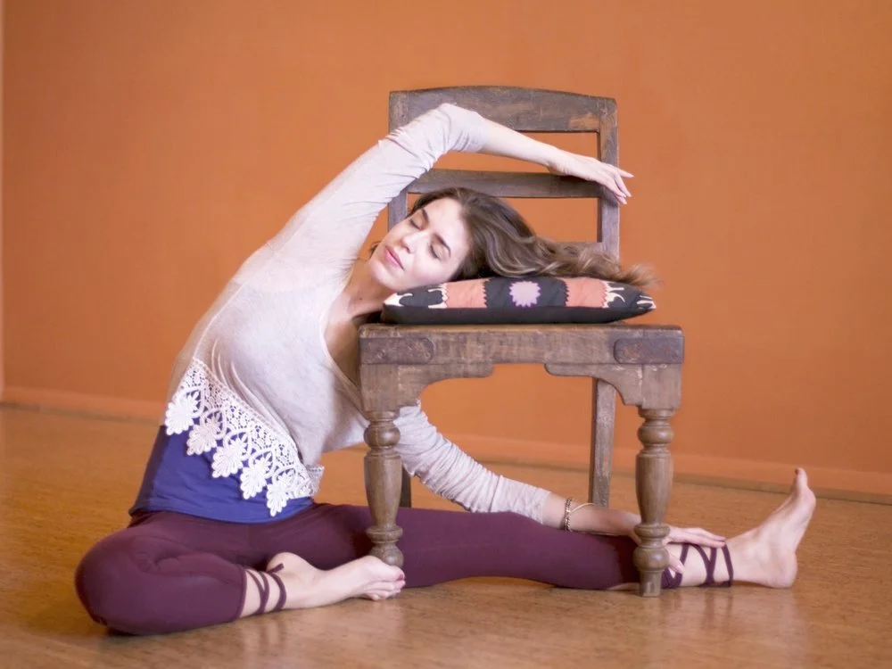 Ann Swanson practicing yoga using a chair