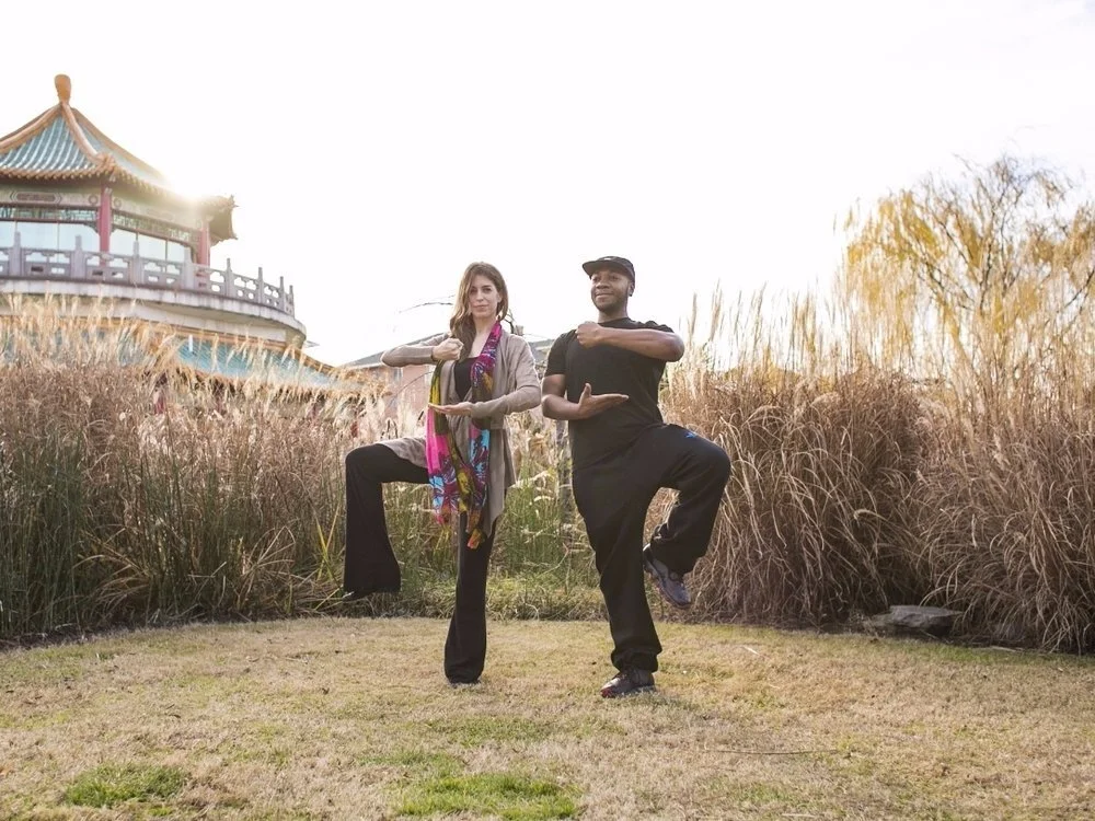 Ann Swanson practicing Qi Gong outdoors with a man