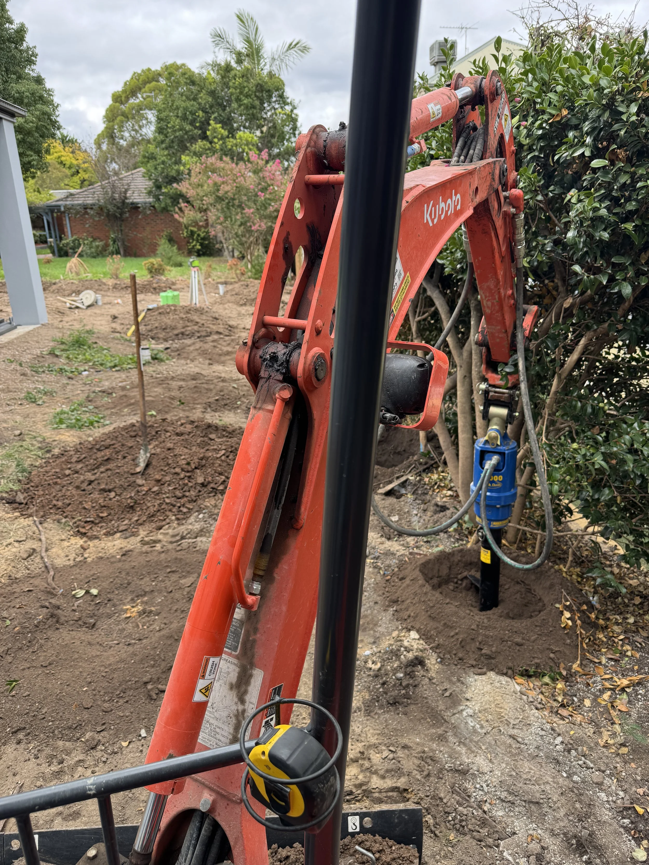 Augering post holes for boundary fence