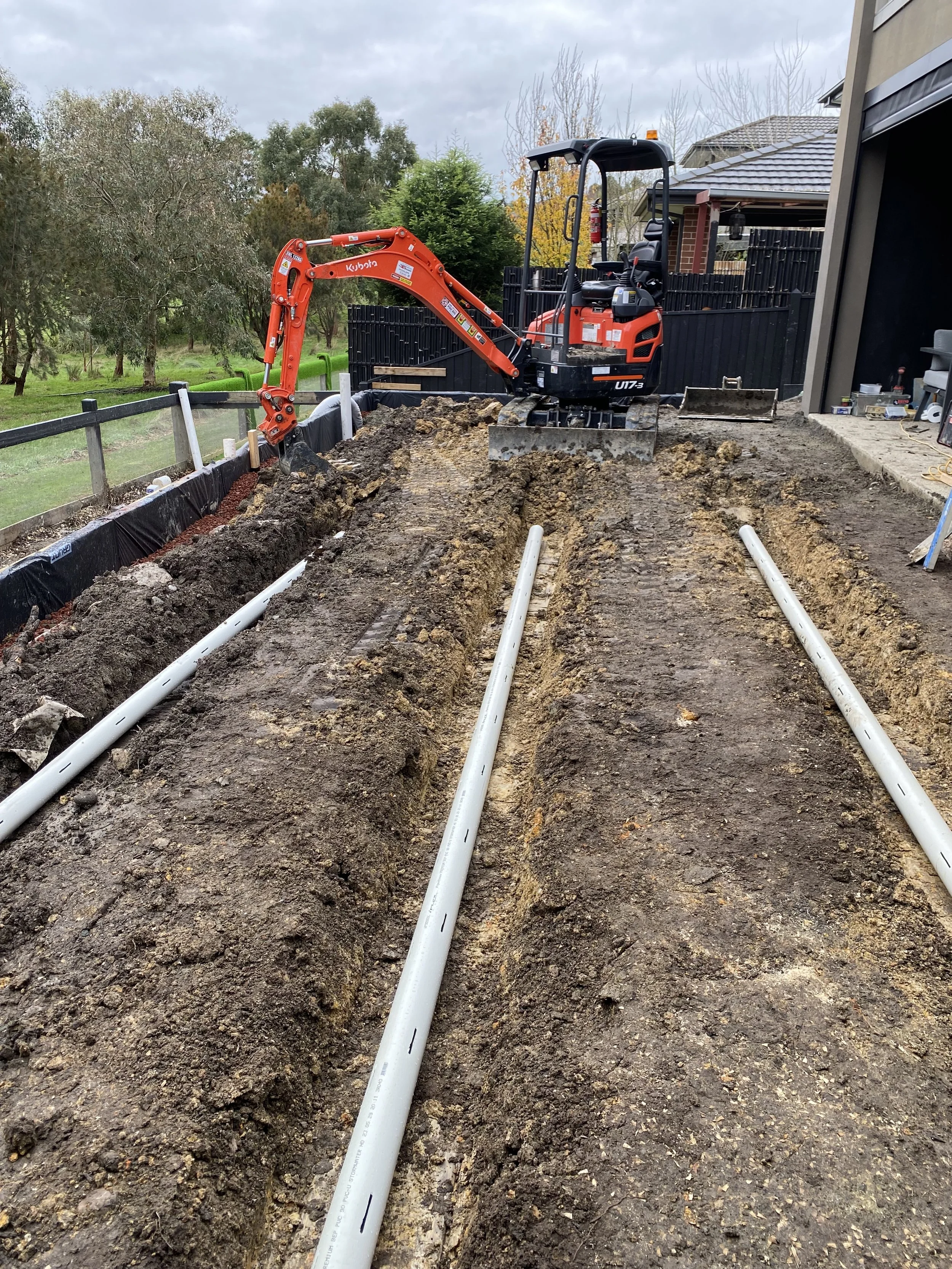 Drainage installed under new turf and behind retaining wall