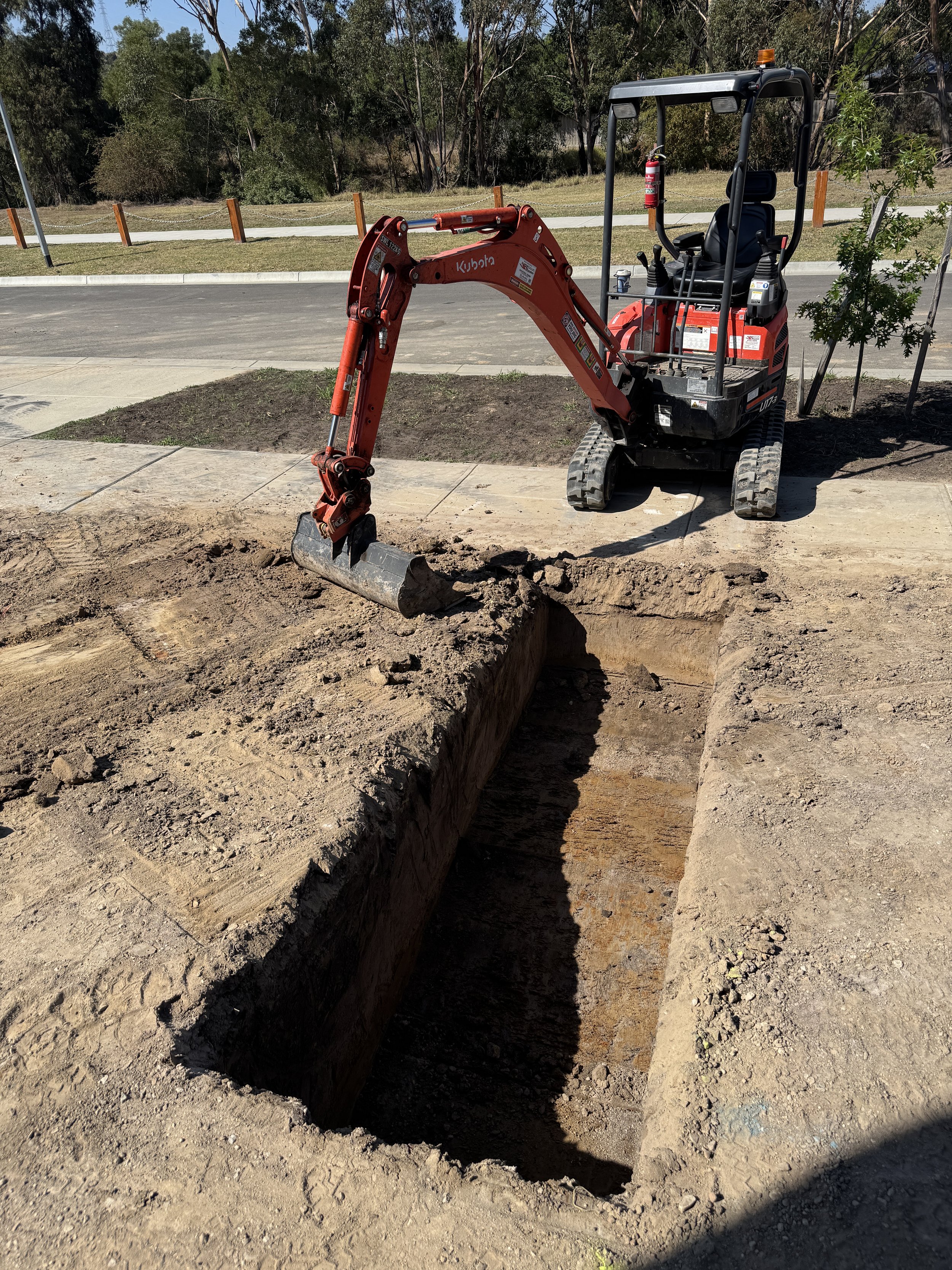 Excavate footing for retaining wall