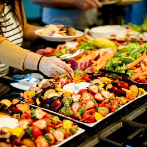 Lavish display of food with women creating a plate
