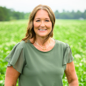 Heidi Alsum-Randall Headshot with farm field in background
