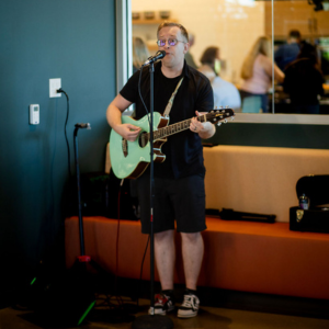 Man playing guitar in hallway
