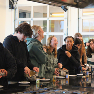 Group of high school students in cooking class laughing