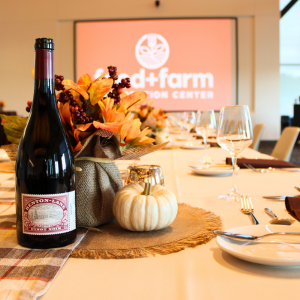 Bottle of wine setup with fall decor for fancy dinner