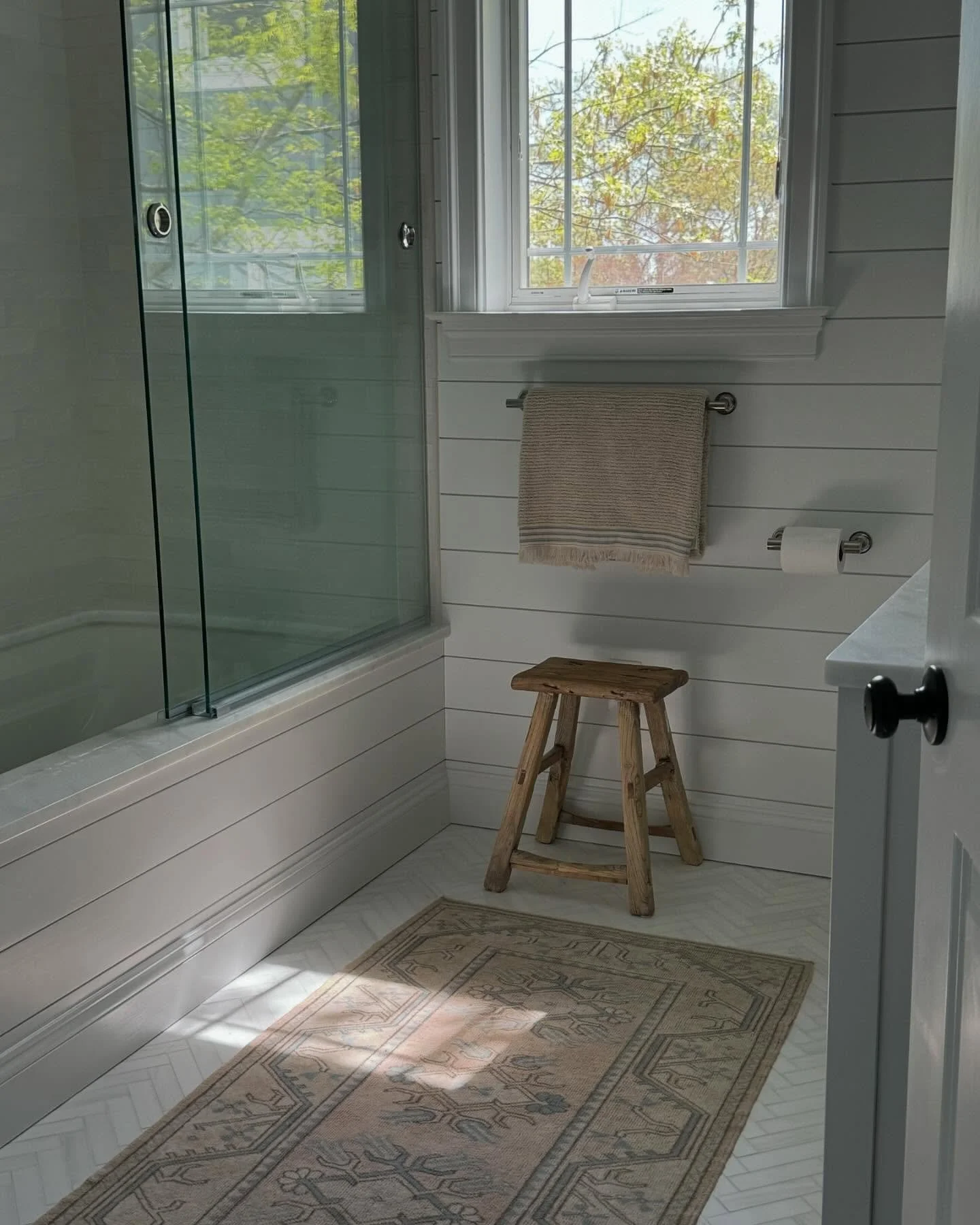 Progress pics of a coastal bathroom renovation from our Thomas Point project! The client requested that this guest bath feel fresh and inviting. We went with a classic shiplap on the walls, herringbone marble on the floors and polished nickel fixture