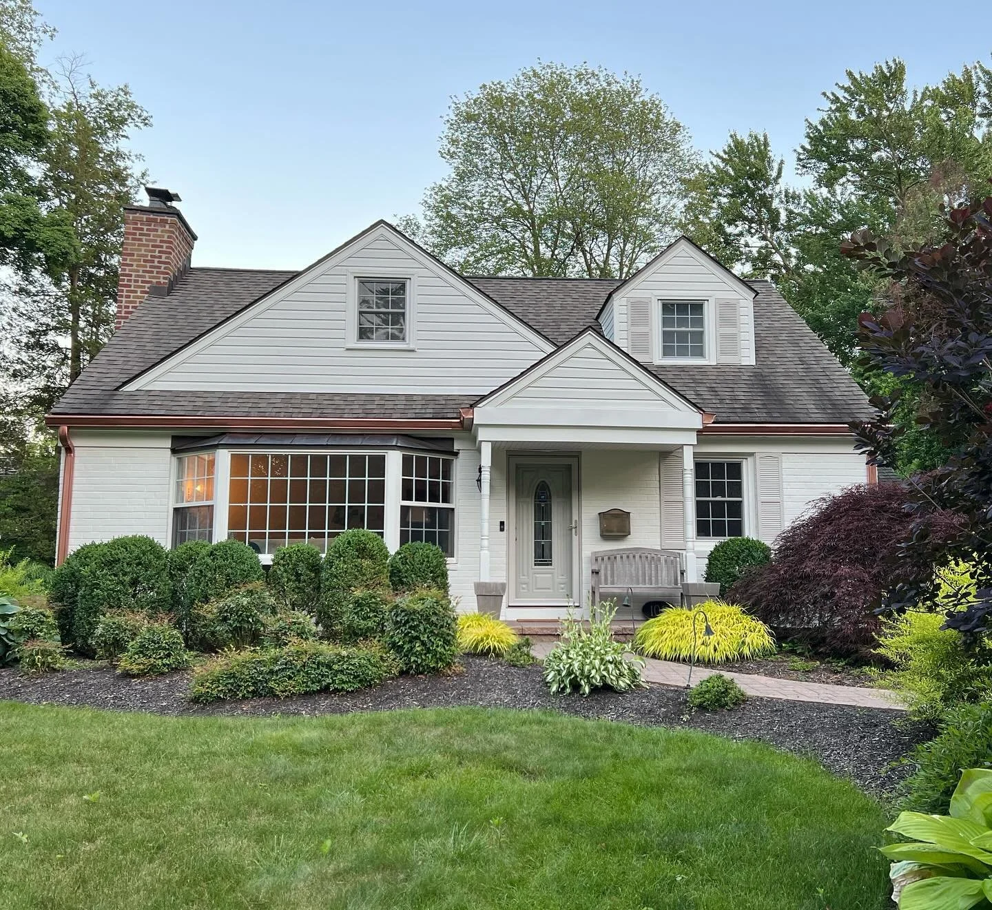 Sometimes it&rsquo;s best to start from the outside and work your way in! The perfect shade of creamy white paint and copper gutters transformed this house from cute to even cuter 🤎 swipe to see the before after