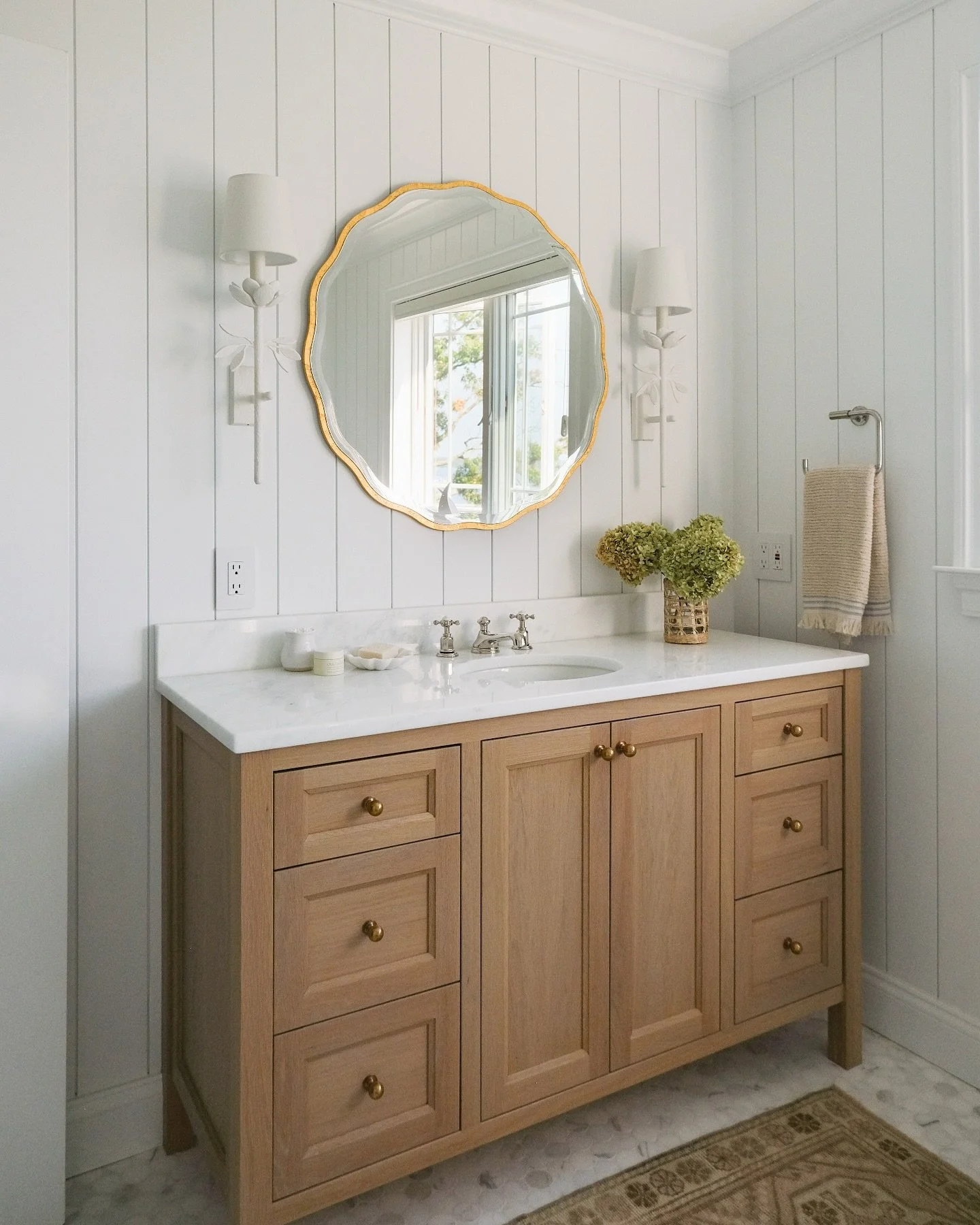Introducing our Thomas Point bathroom renovation before and after - from dated teal to a light-filled retreat! We replaced heavy finishes with soft neutrals, warm wood tones, and classic fixtures. Shiplap walls and natural light brought the freshness