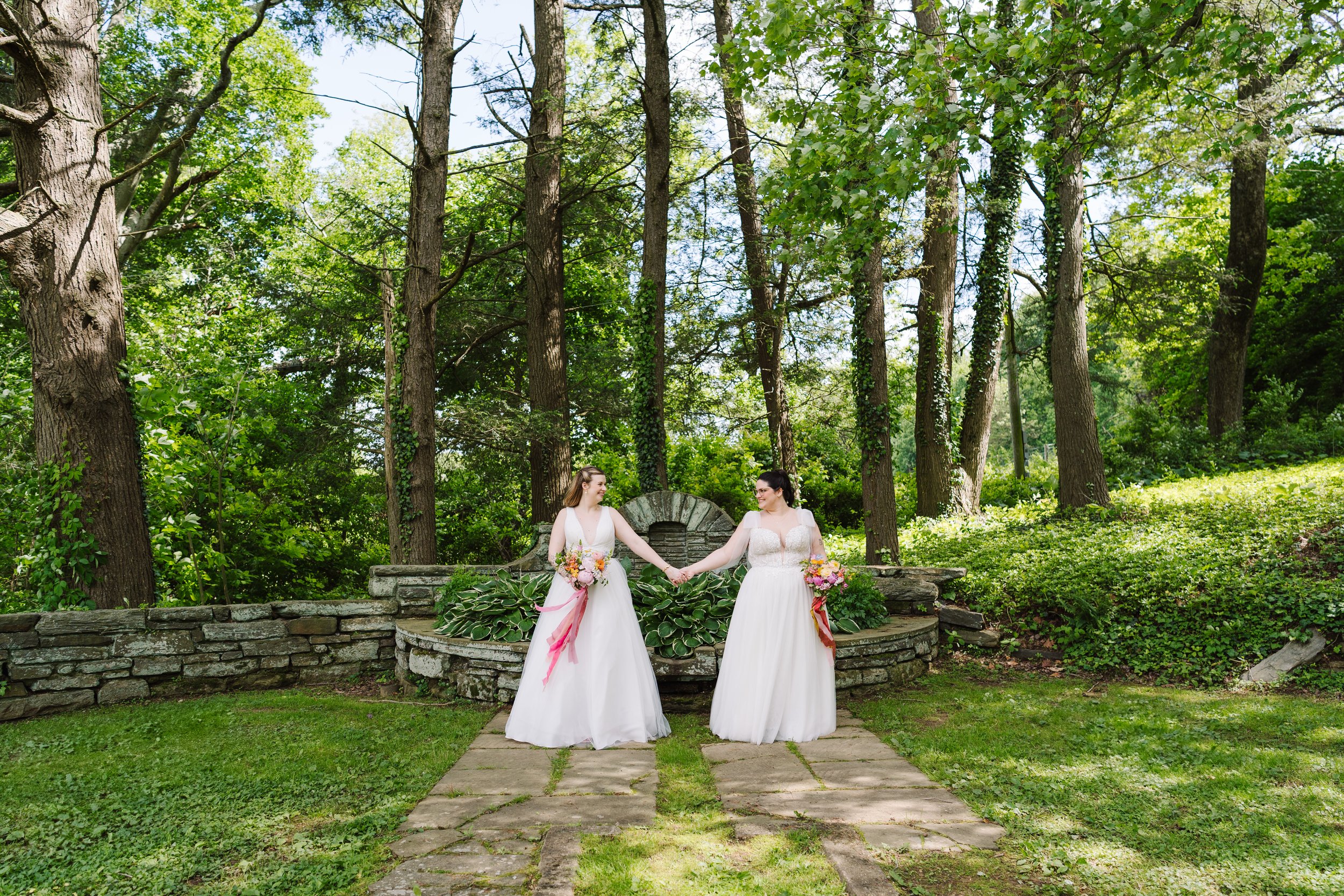 Brides holding hands at The Willows at Villanova