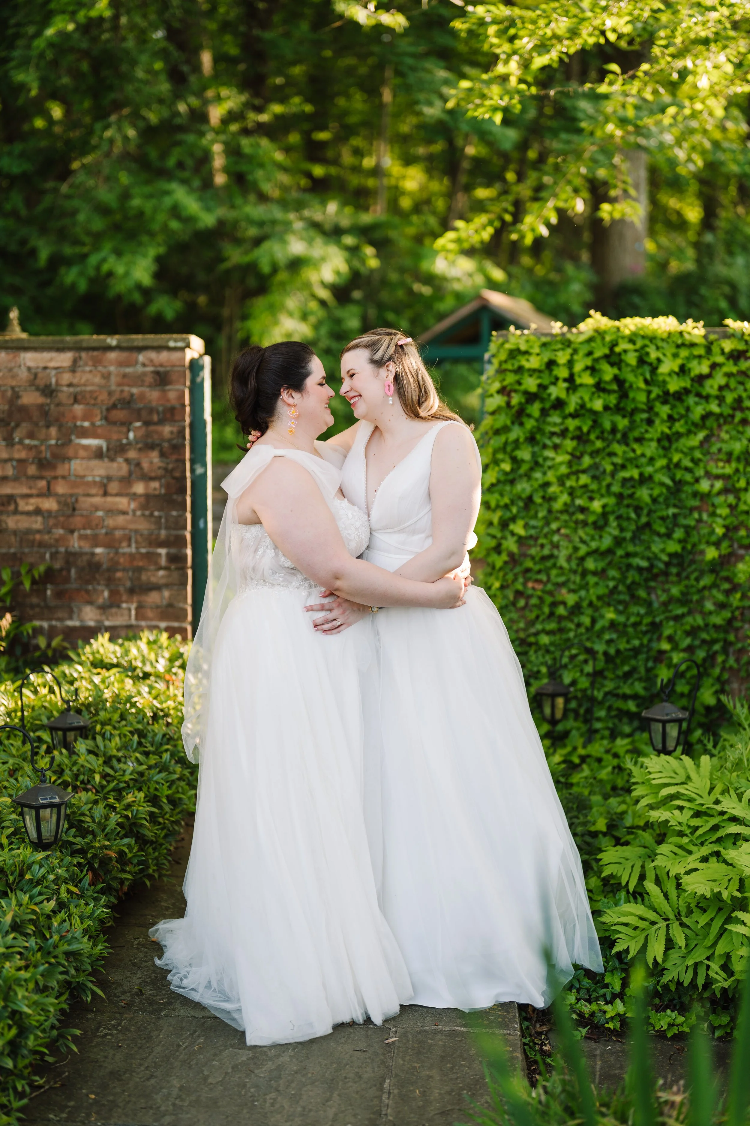 Brides embracing during sunset at The Willows at Villanova