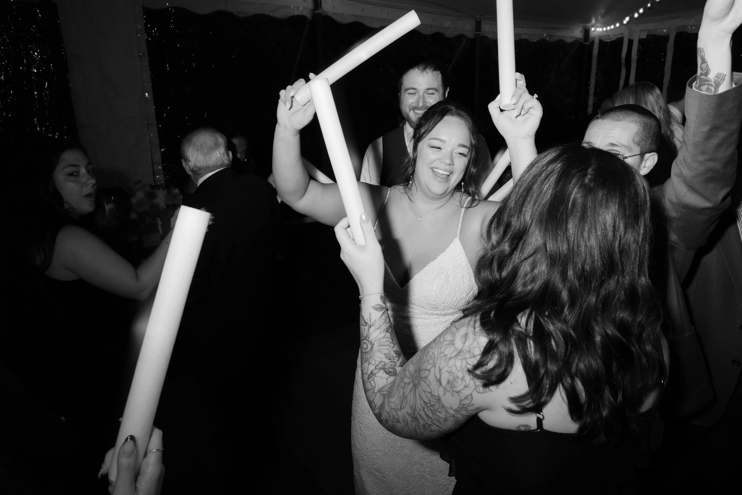 Bride dancing with guests at her wedding reception.
