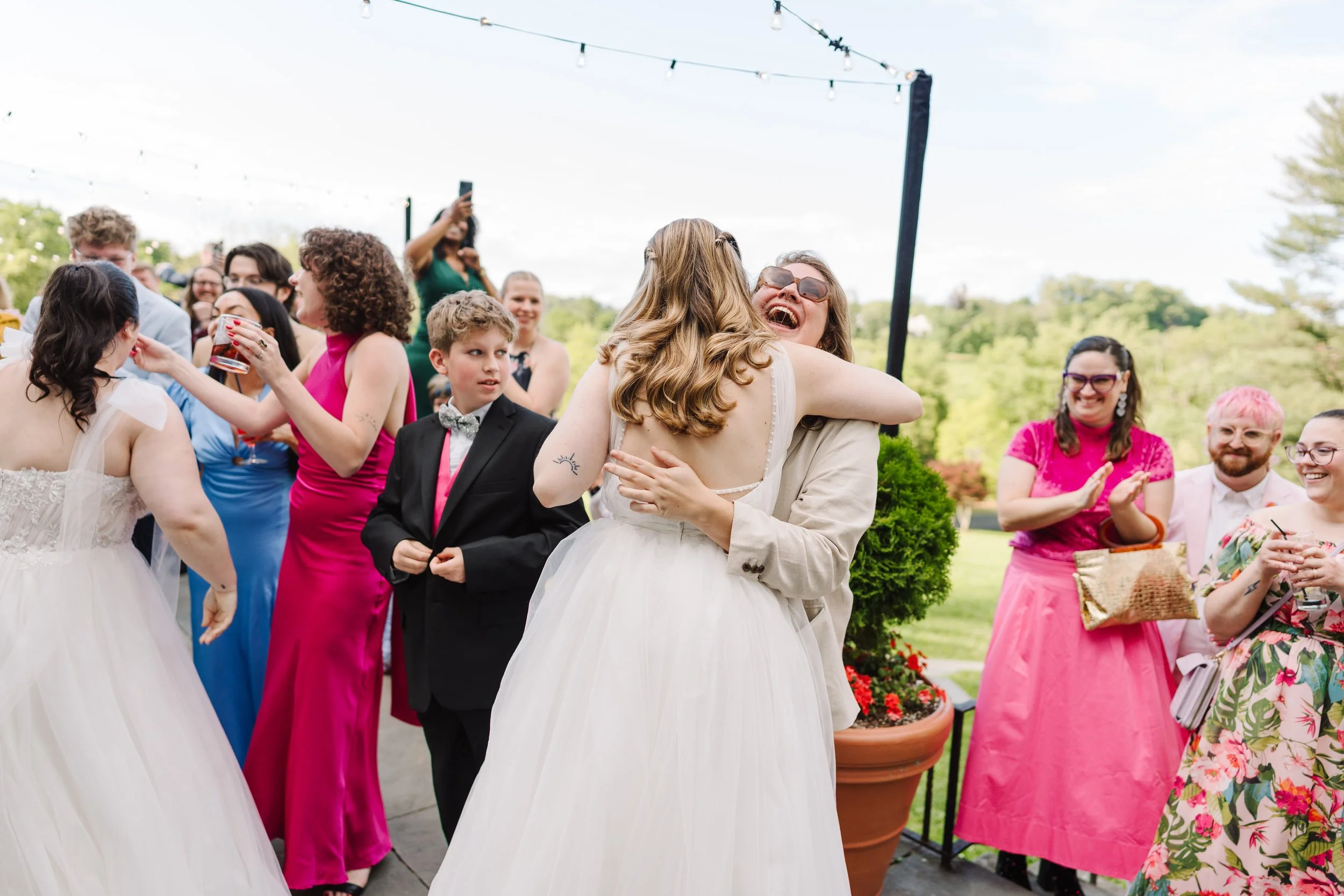 Bride hugging a guest at cocktail hour.