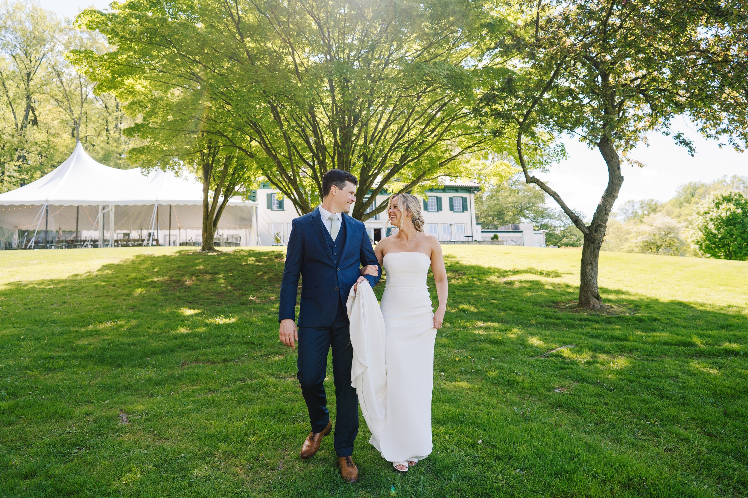 Bride and Groom walking down the hill at The Willows at Villanova