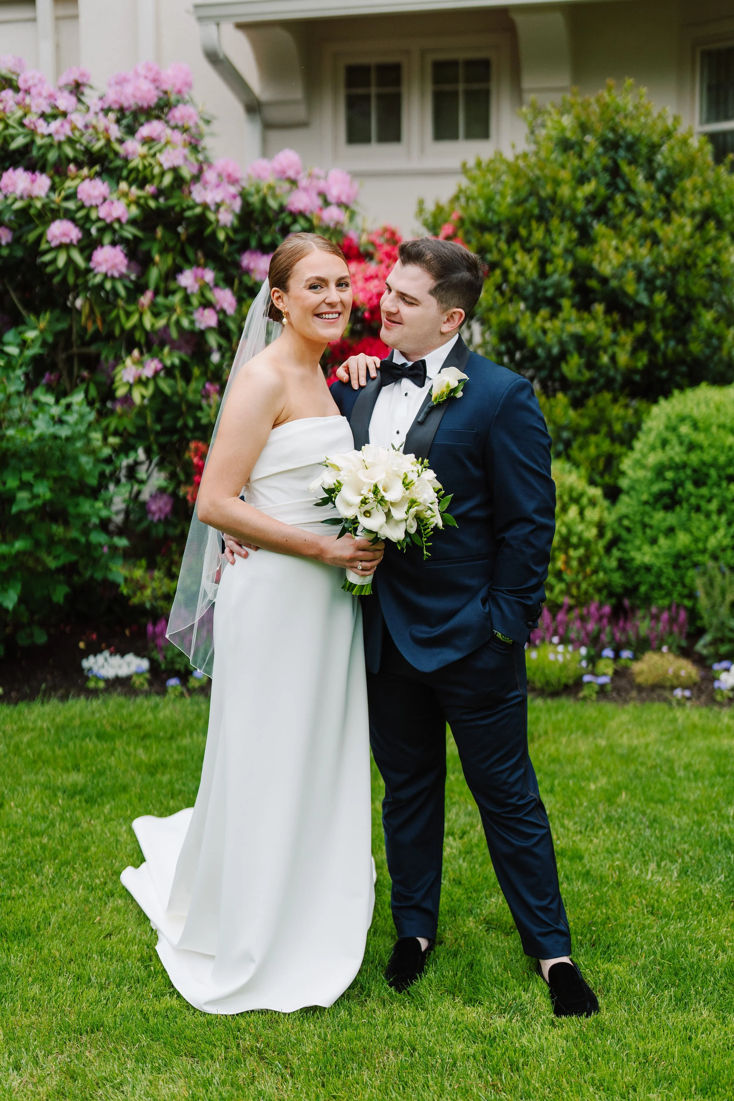 Bride and groom posing together during outdoor wedding portraits, photographed by Philadelphia wedding photographers with a natural, candid style.