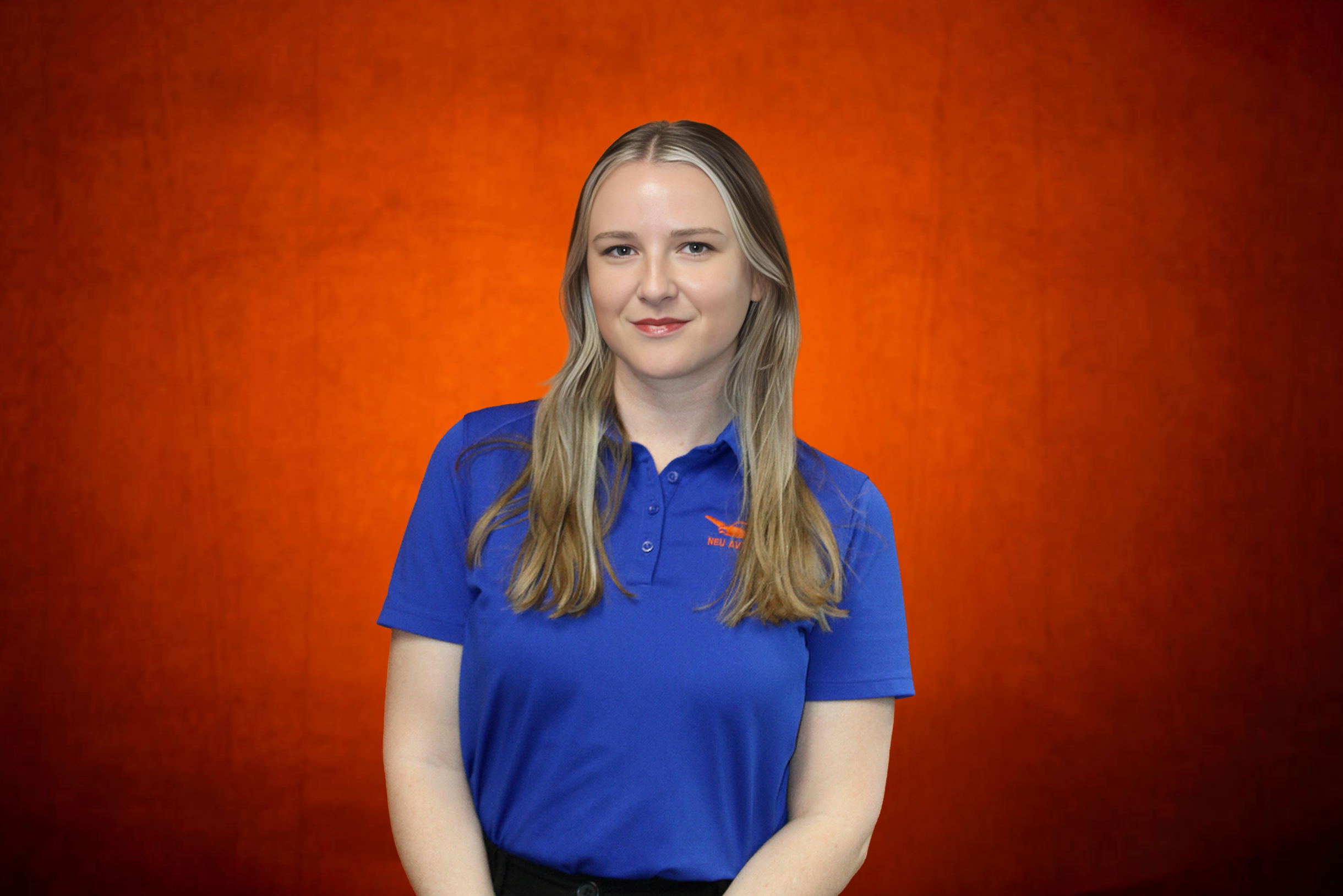Young woman with blonde hair wearing a white polo shirt with an airplane logo and the words 'NEU AVIATION' on a red textured background.
