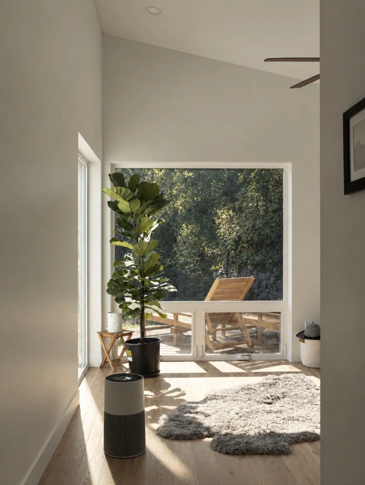 Light-filled primary suite addition in Washington designed by Anthropos Design Studio, with large windows framing the Pacific Northwest landscape.