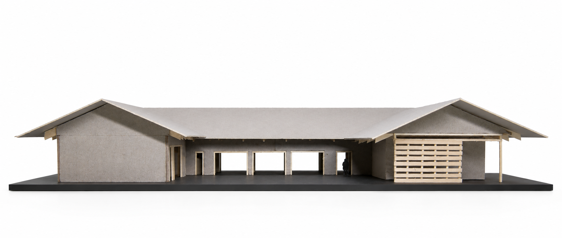 Physical architectural model of Kona House in Hawaii showing the rear elevation, connected gable roof forms, open breezeway, and horizontal wood screen.