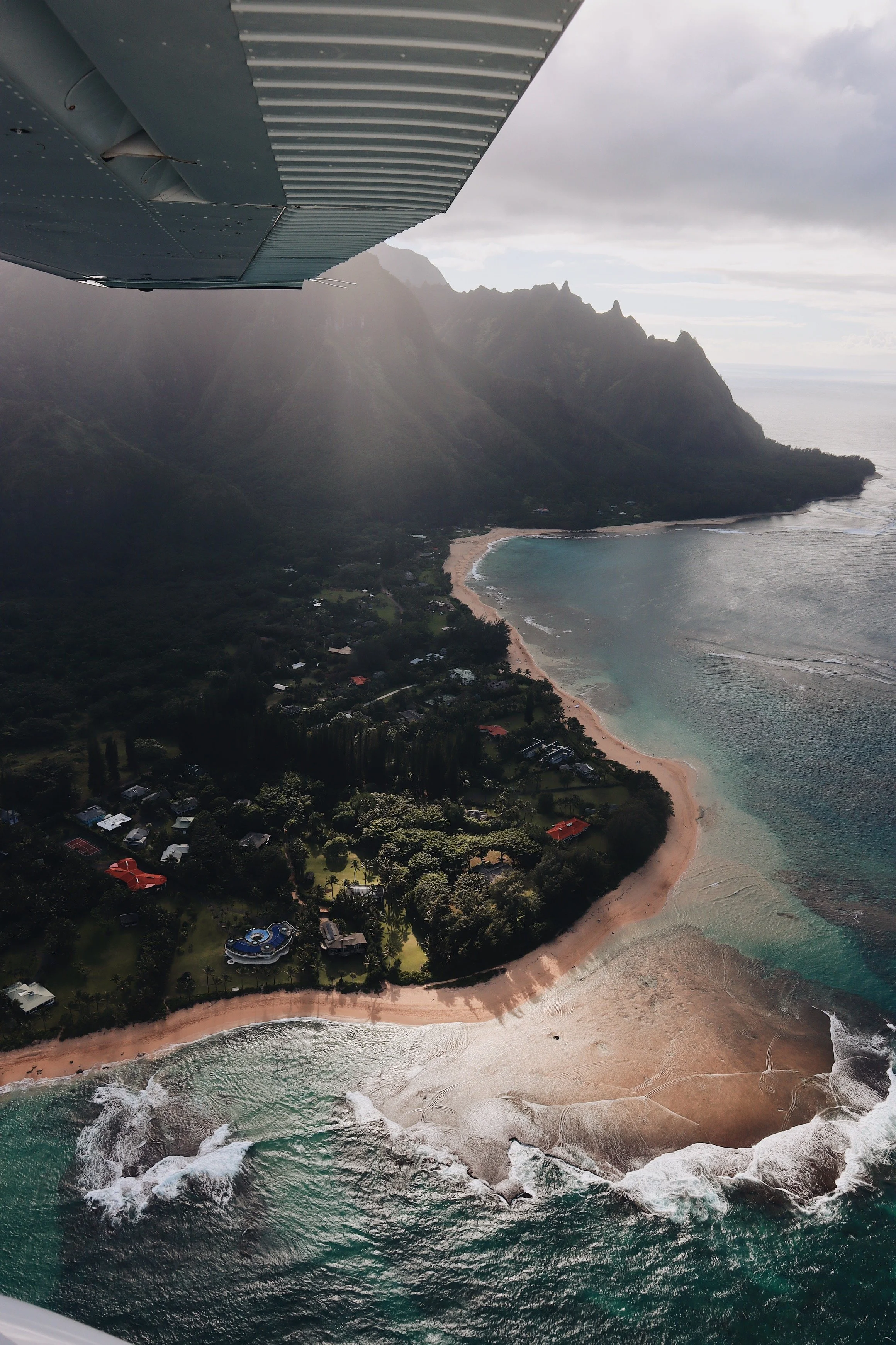 Aerial view of the dramatic Hawaii coastline, tropical landscape, mountains, and Pacific Ocean near the Kona House project.