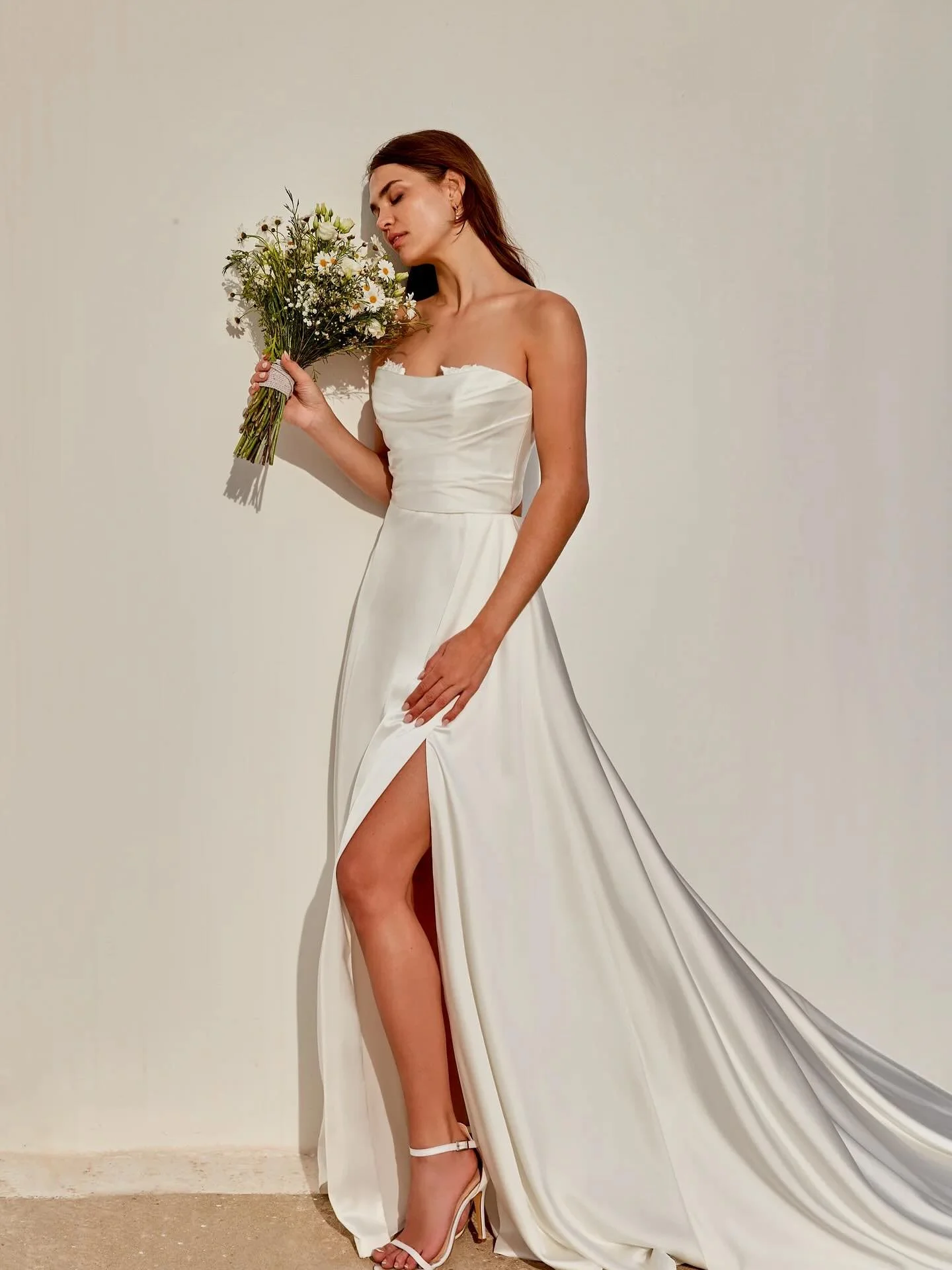 Smooth as silk 🥀 Our newest charmeause Adore gown is the perfect silky smooth, flowy gown. Features a ruched peek a boo lace bodice, with unique keyhole back.

#adorebyjustinalexander #weddinggown #satin #charmeause #keyholeback #legslit #weddingdre