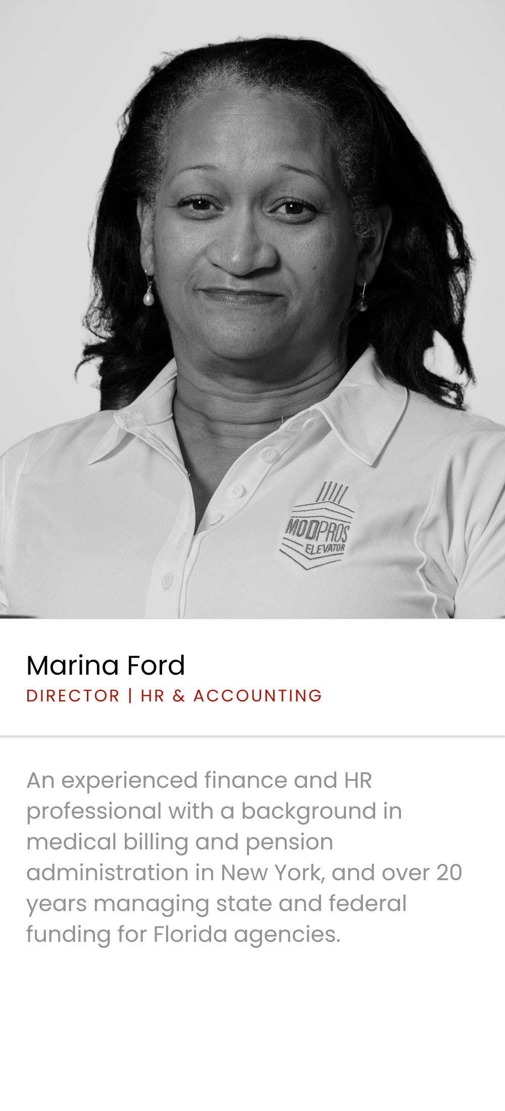 Black and white portrait of Marina Ford, an African American woman with shoulder-length curly hair, wearing a collared shirt with a logo that reads 'MOD PROS ELEVATOR'. She is smiling slightly and wearing earrings.
