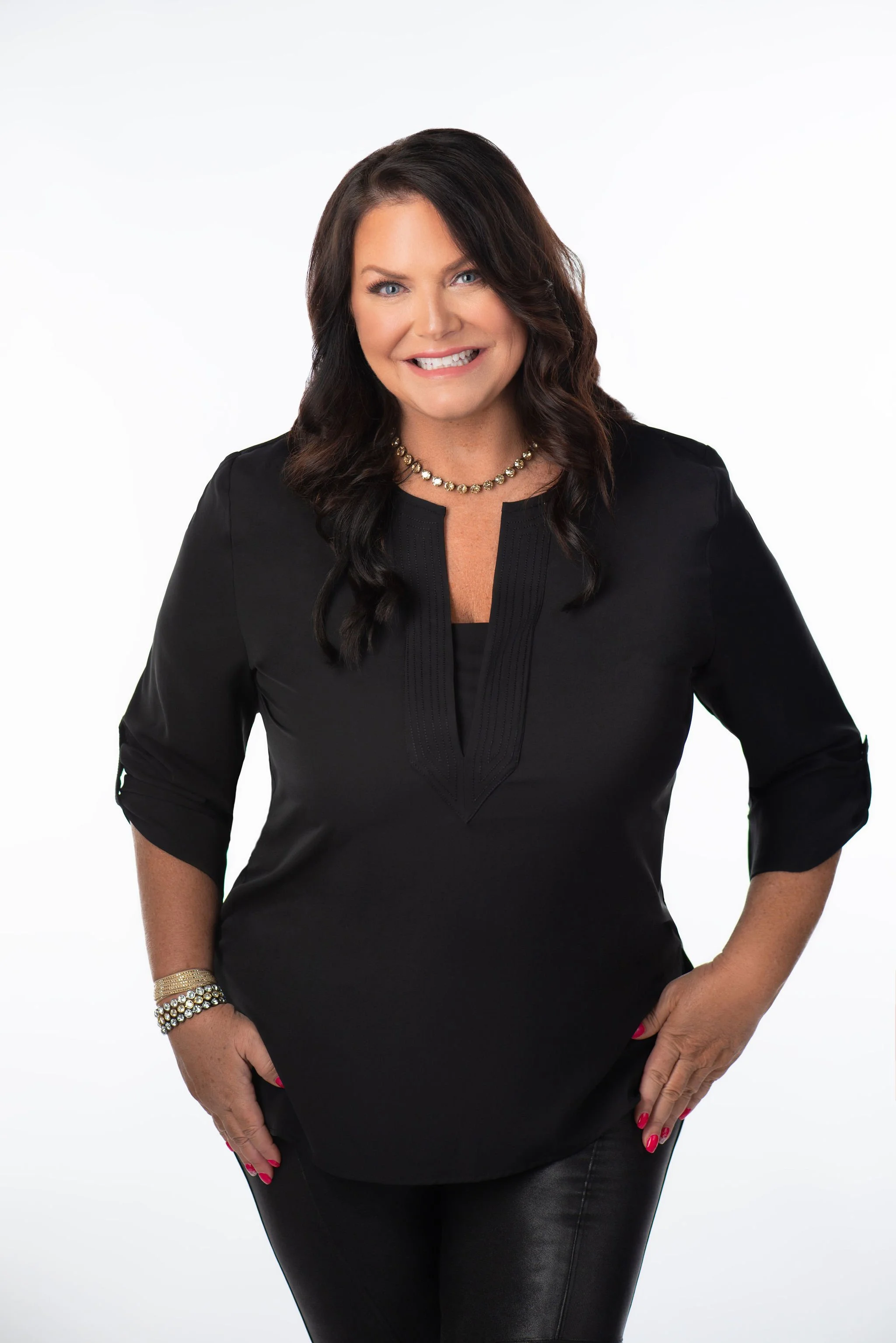 Smiling woman in black top against white background