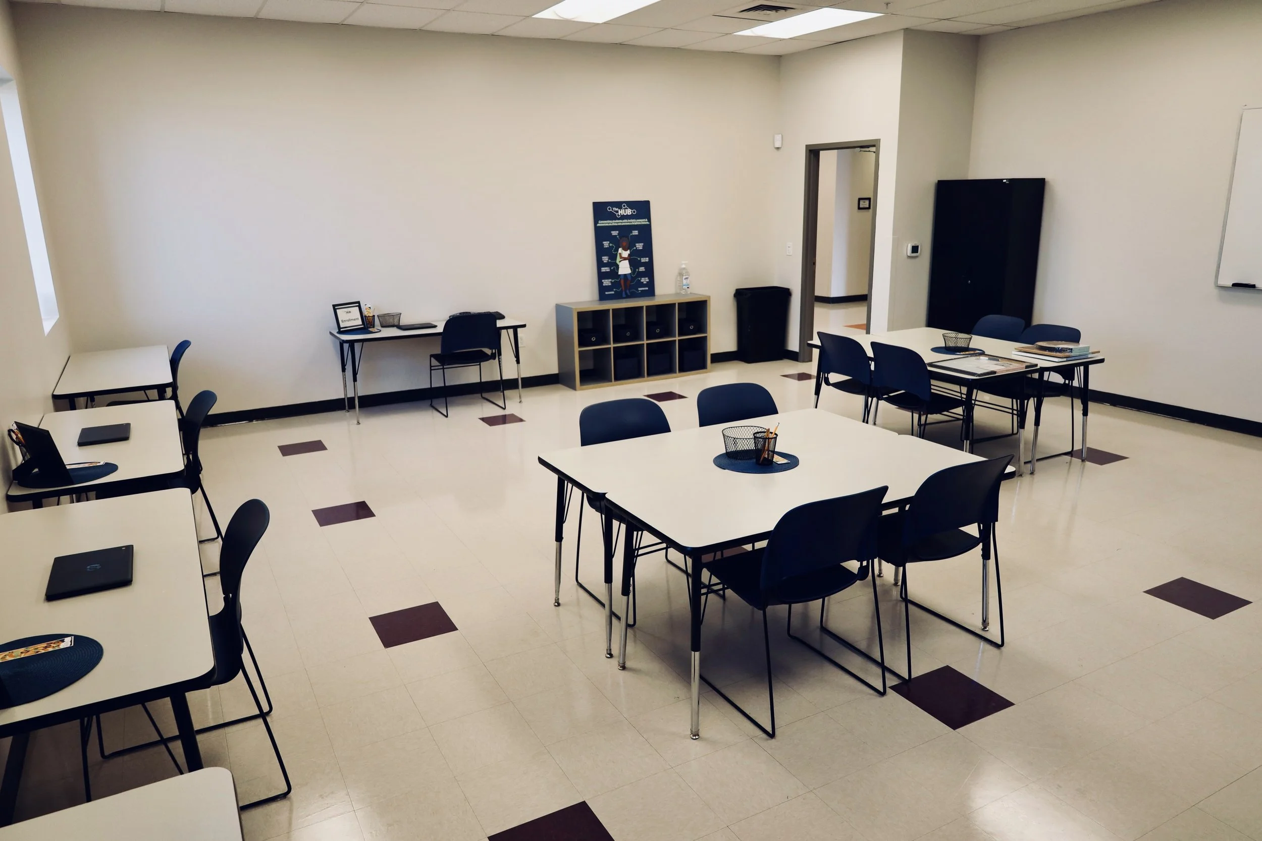 A study area for students filled with tables with chairs and desks