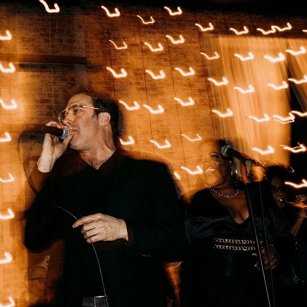 portrait of man singing at an event