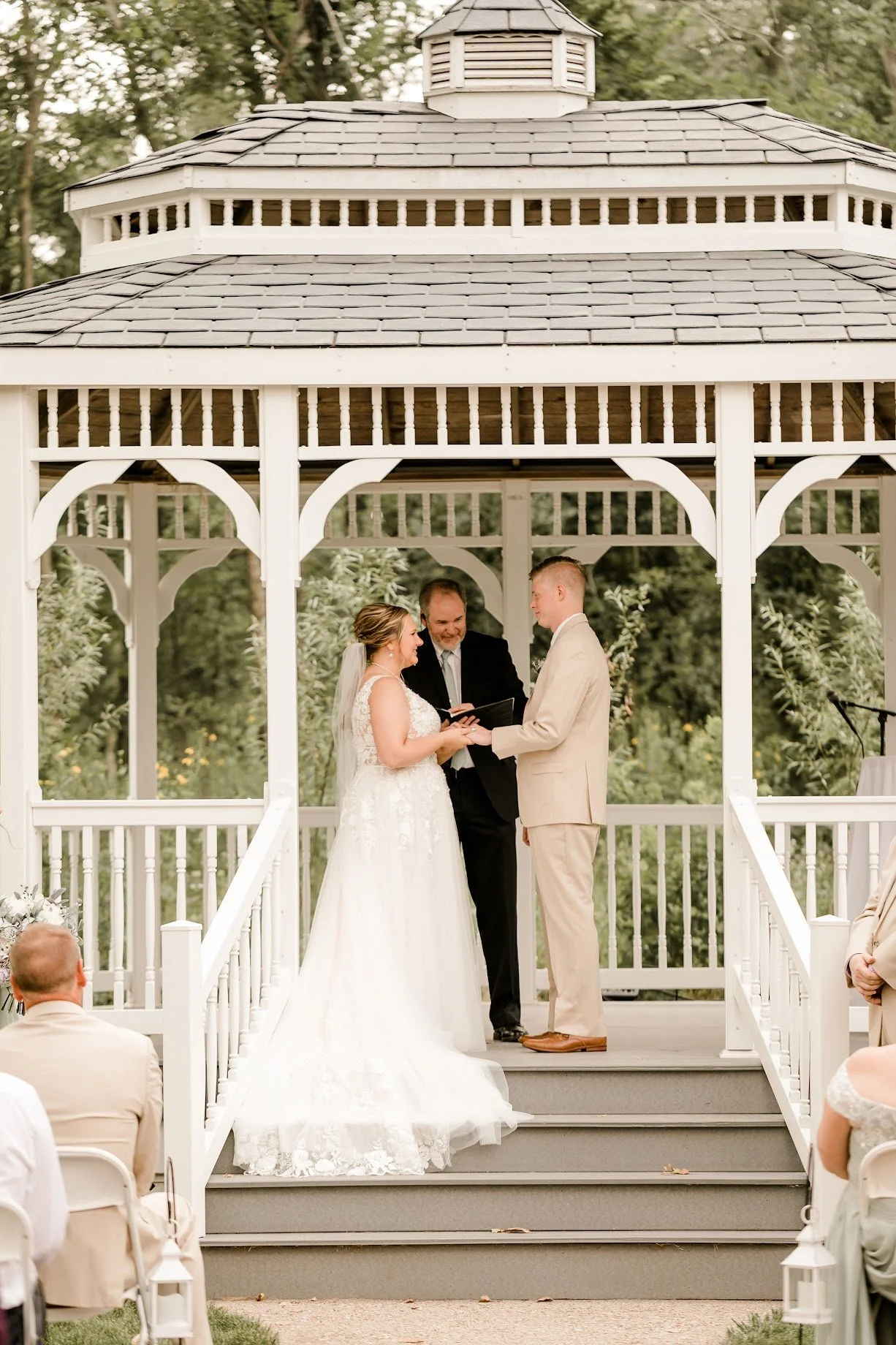 Newly married couple taking wedding photos during golden hour at an outdoor Iowa wedding venue.