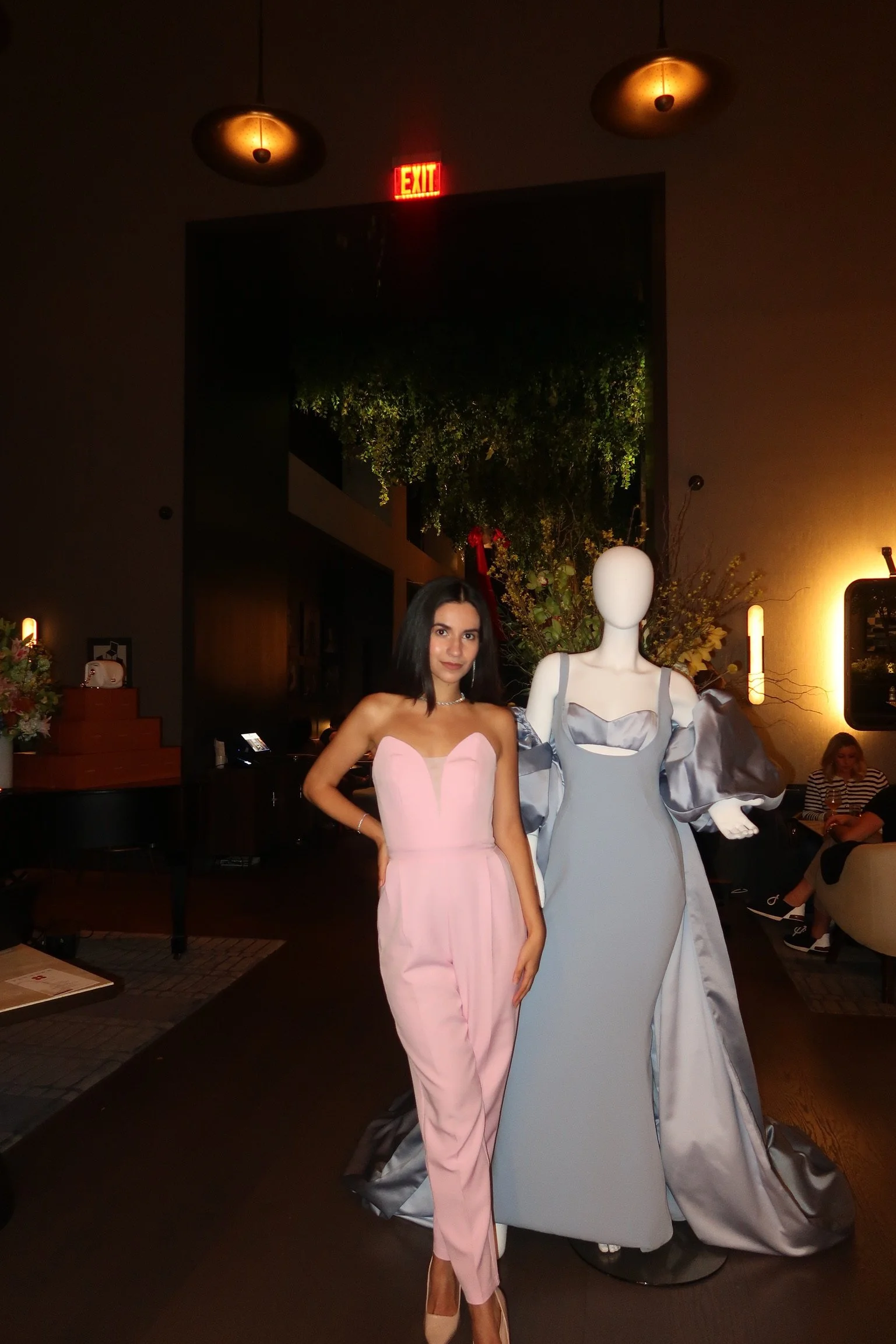 Guest posing next to a mannequin