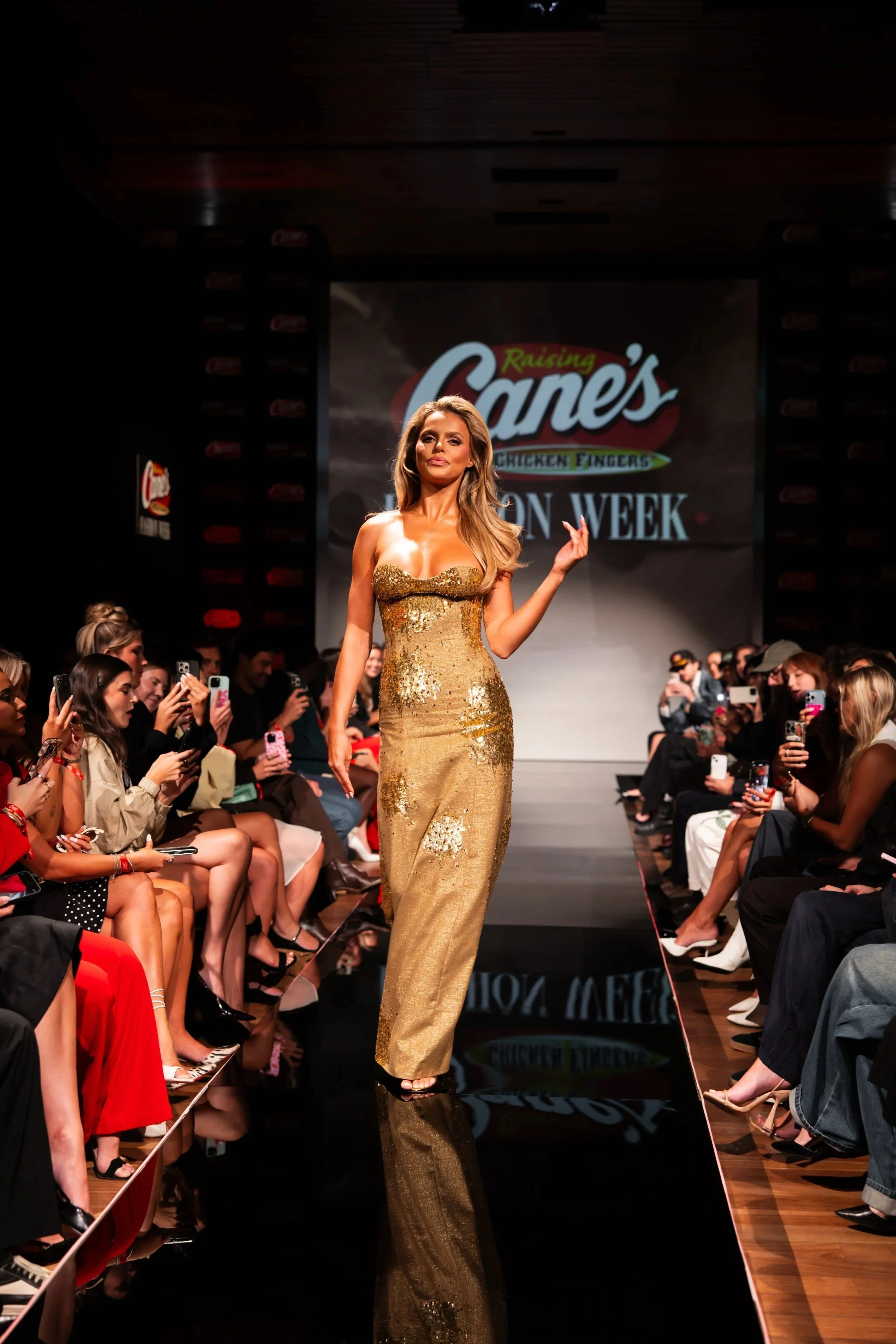 Model in a gold sequined gown at Raising Cane’s Fashion Week