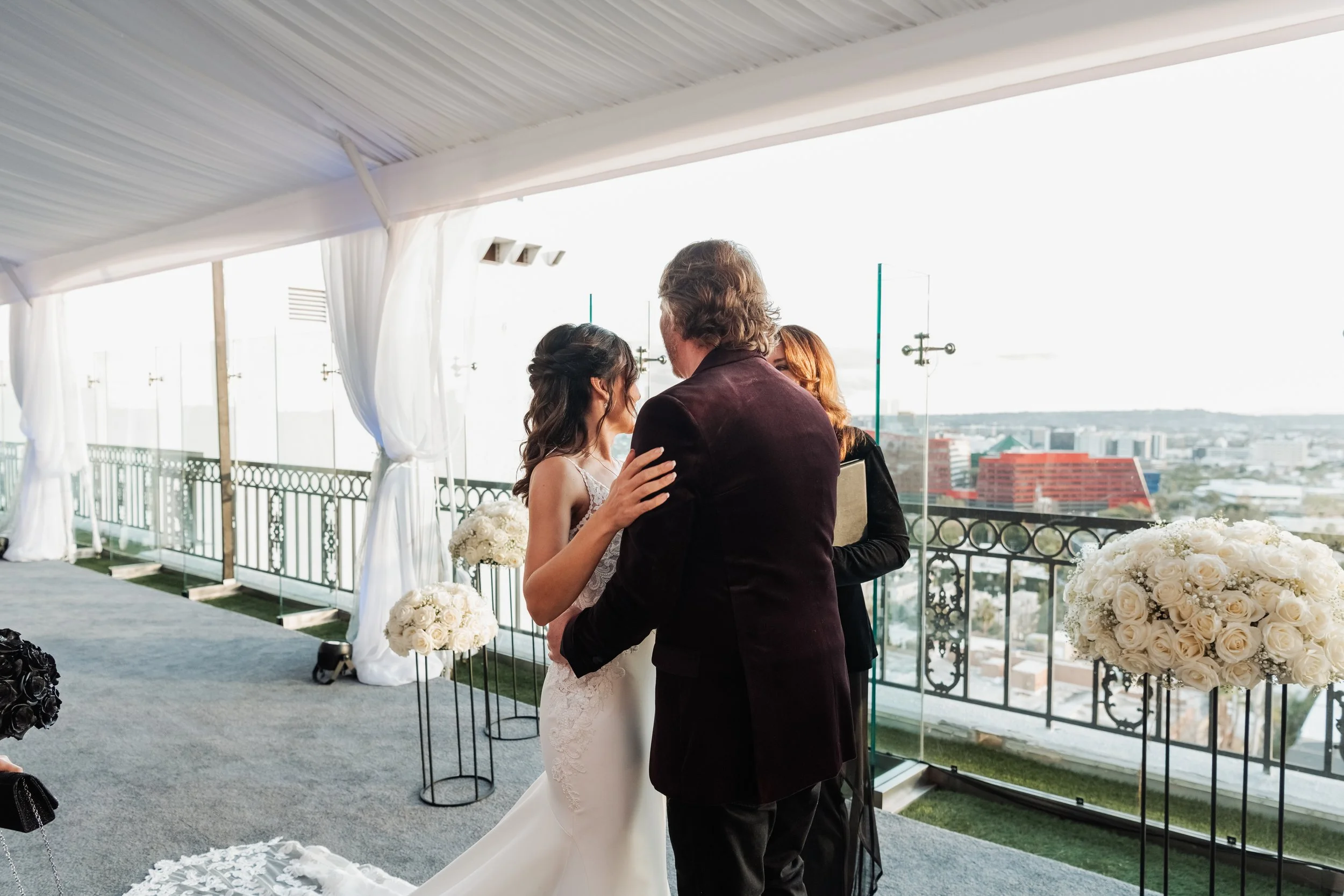 White roses on pedestals for a wedding ceremony altar installation in West Hollywood