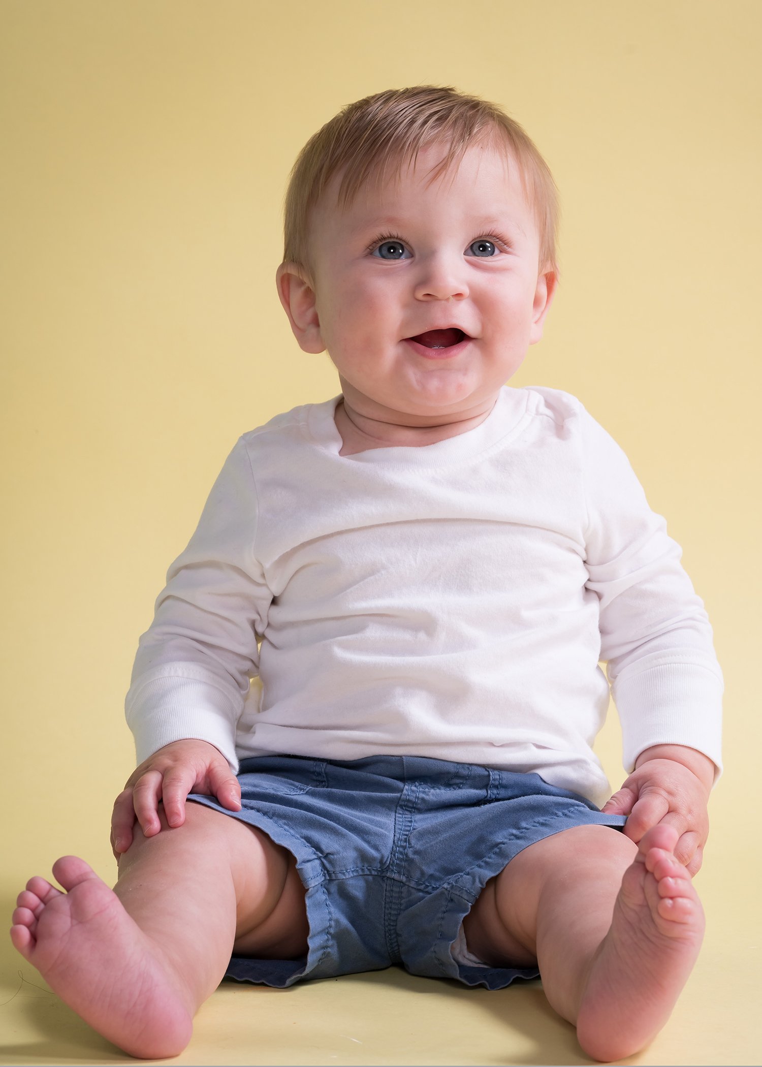 smiling baby on yellow studio.JPG