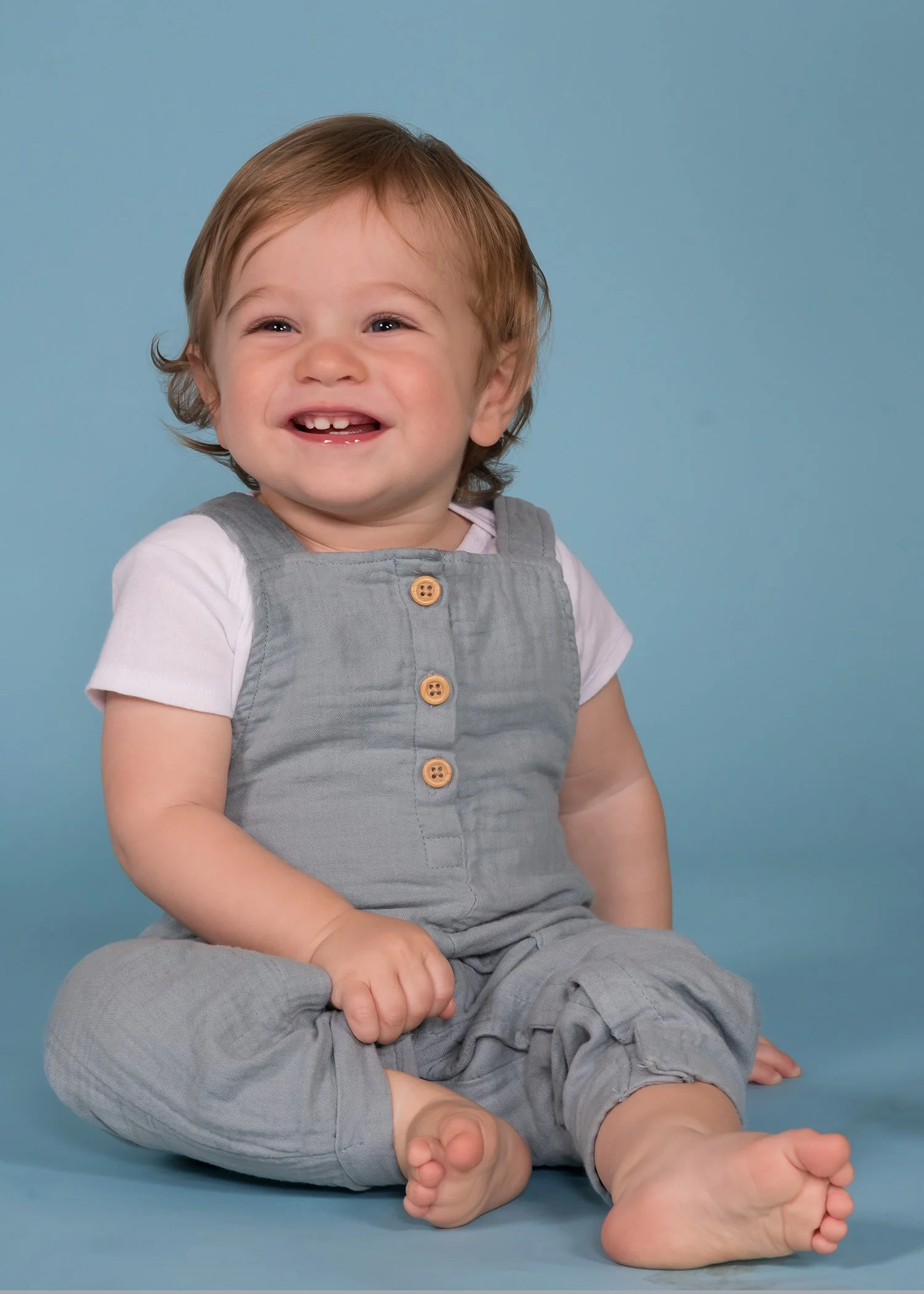 smiling baby portrait blue studio portrait.JPG