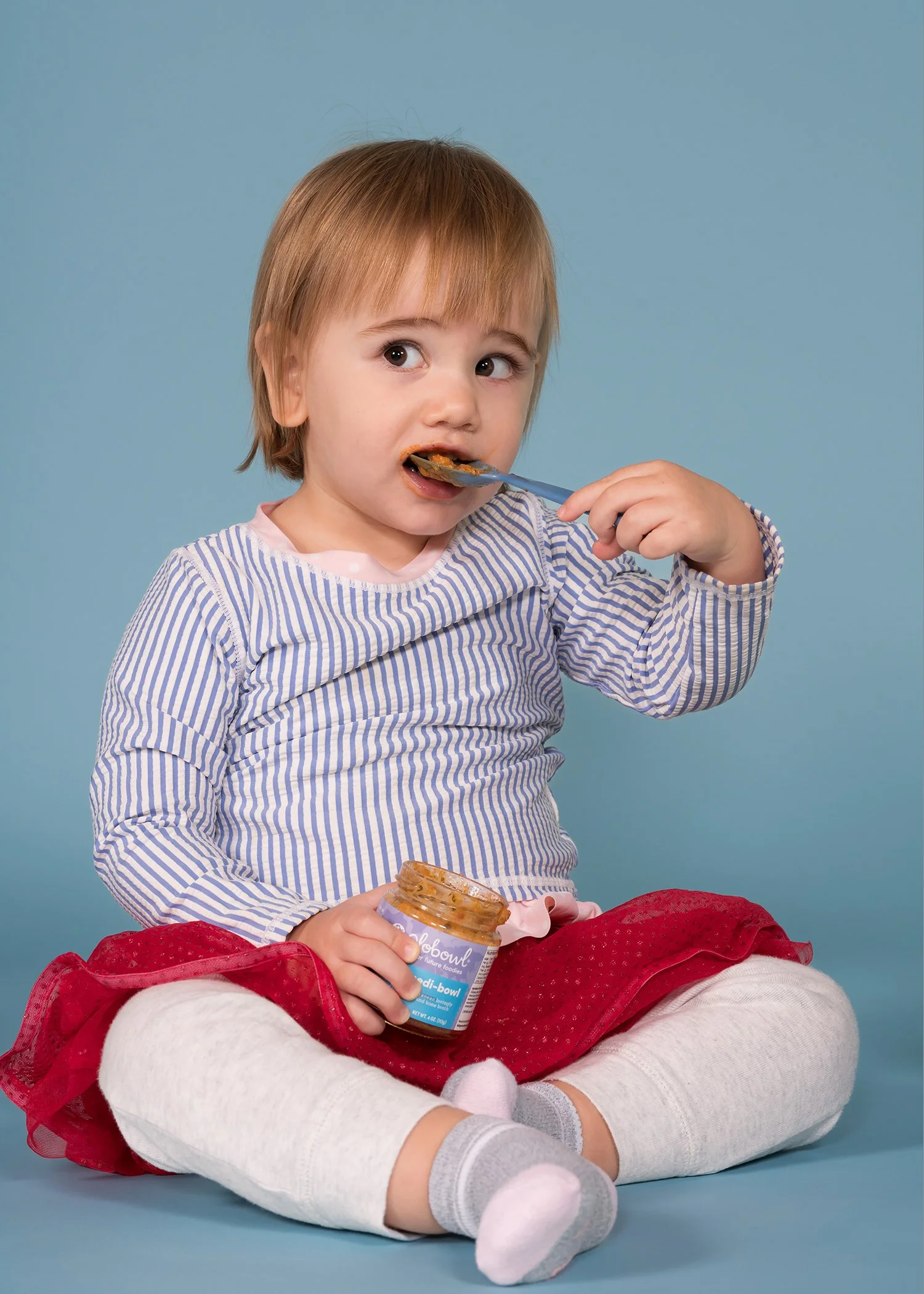 toddler girl eating baby food life tyle portrait.JPG