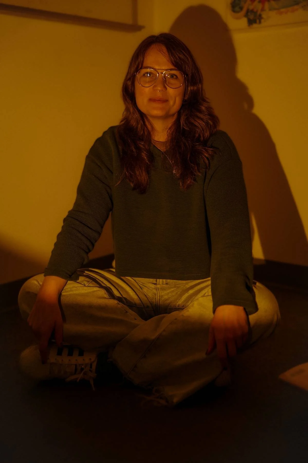 woman sitting crosslegged and smiling