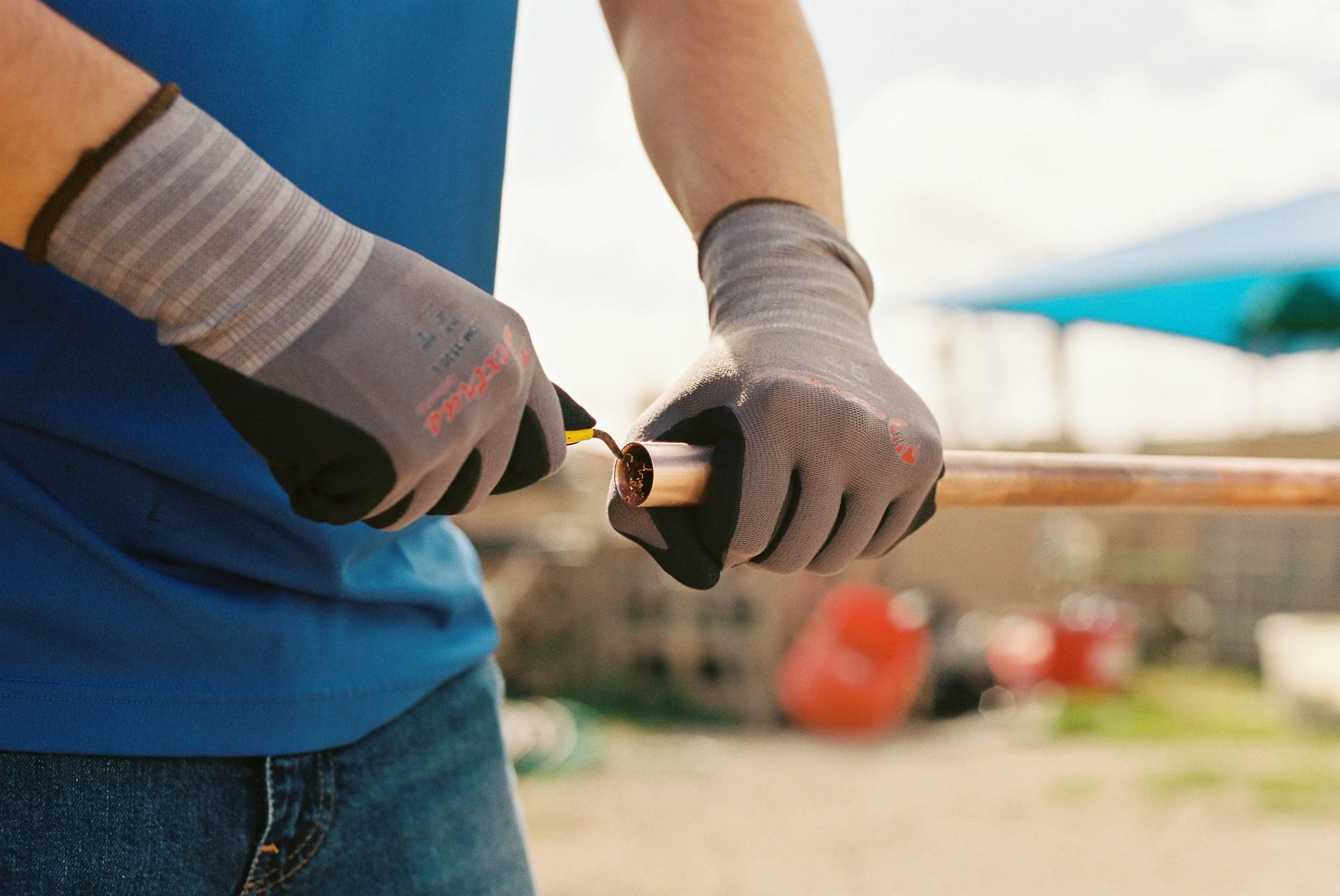 Plumber Reams Copper Pipe Before Soldering