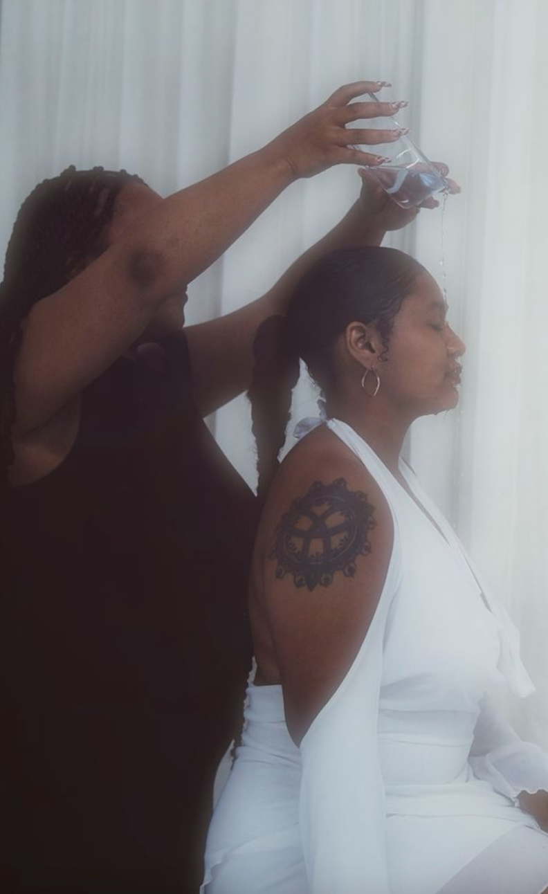 Consecration
(30x40in):

A quiet ritual unfolds. Ancestral, sacred, alive. Calm in presence, holding the memory of renewal through the act of water. 
Black womanhood is a ceremony; not performative, but elemental.

 Women are a ritual. Keepers of tra