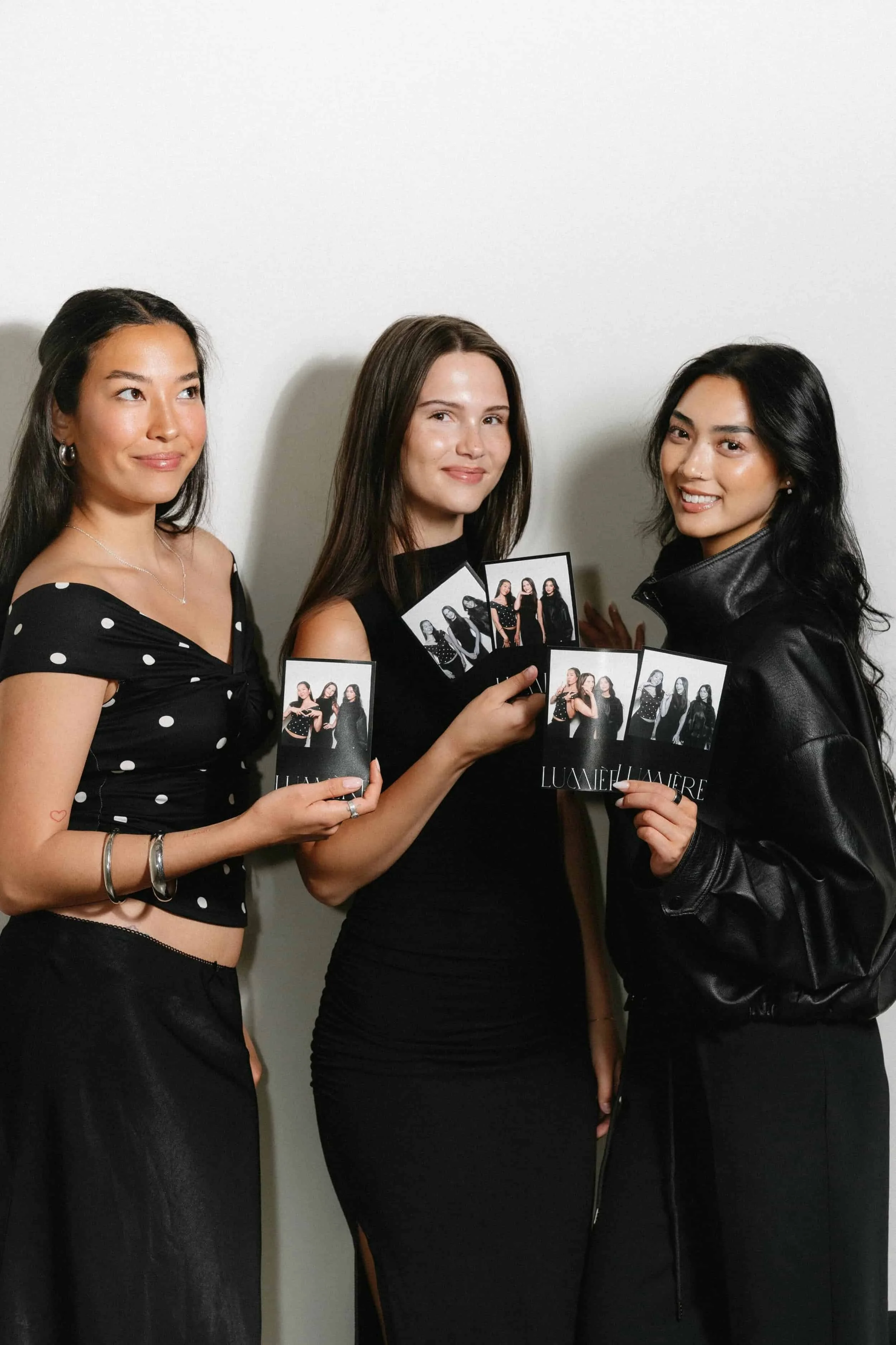 Diverse cast of women guests posing with their 4x6 Photos Taken By Perfect Capture Booth