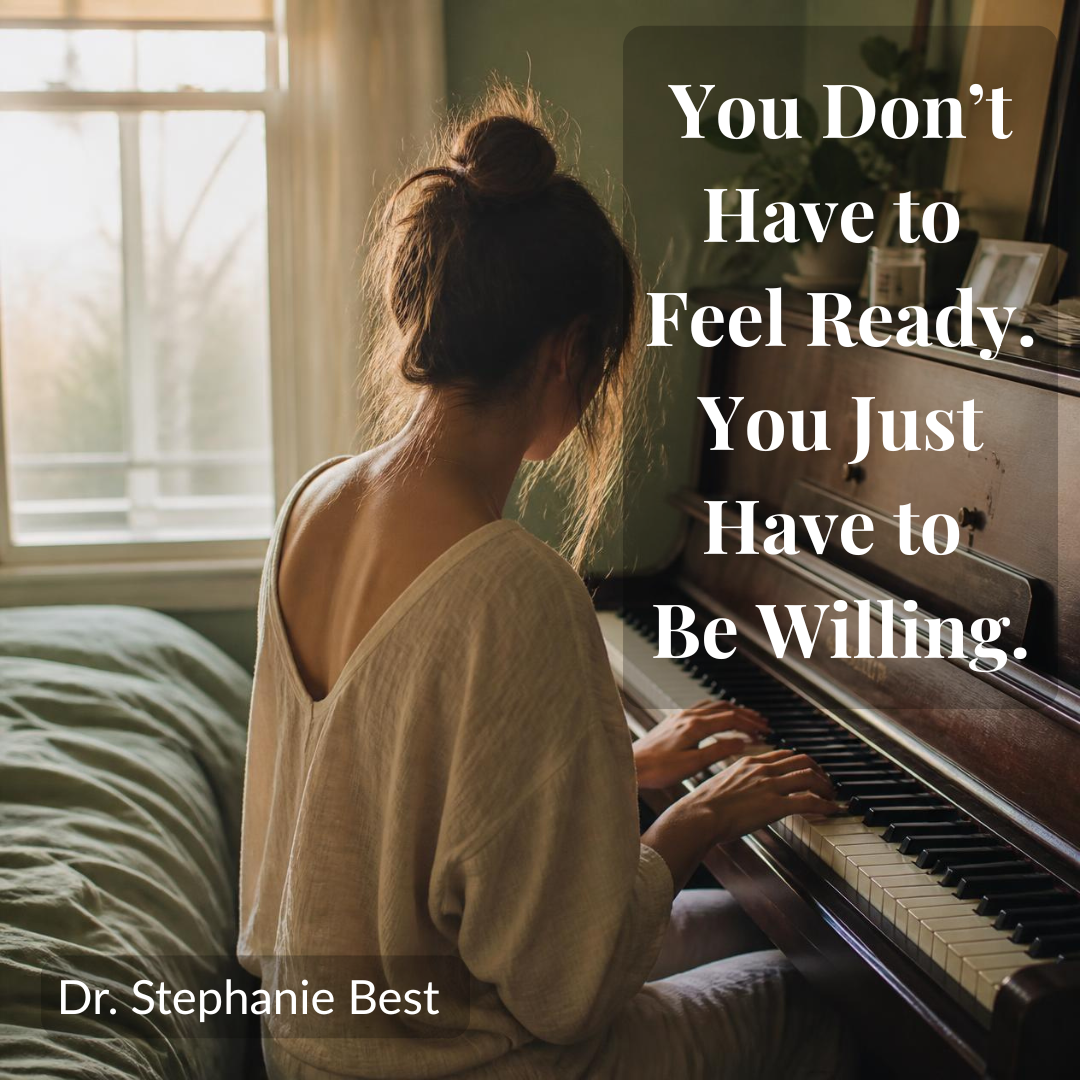 Woman sitting at an upright piano with hands resting on the keys, illustrating how to face your fears