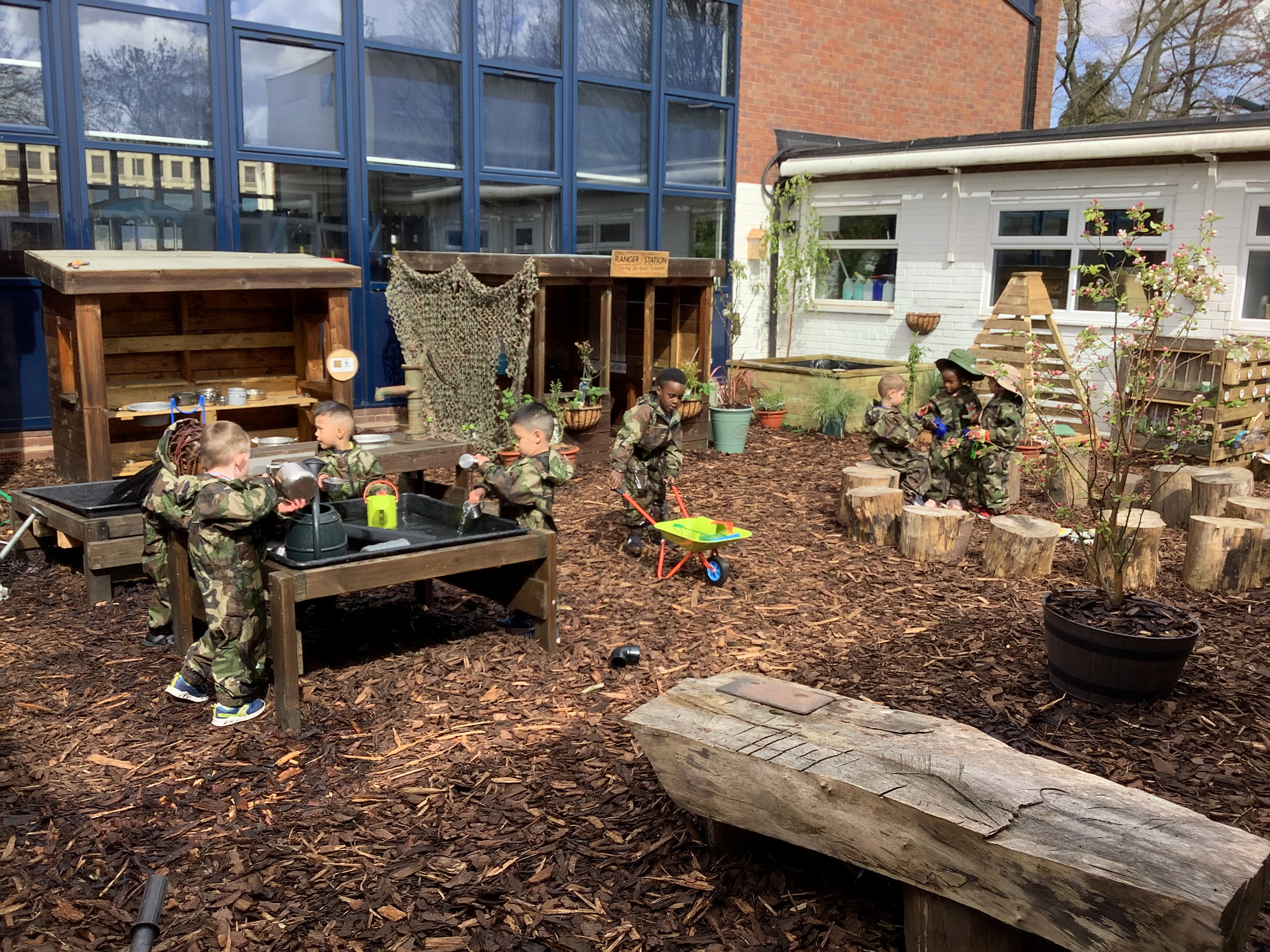 Photo of children playing and exploring The Nest at St Catherine of Siena Catholic Primary School (Nursery).