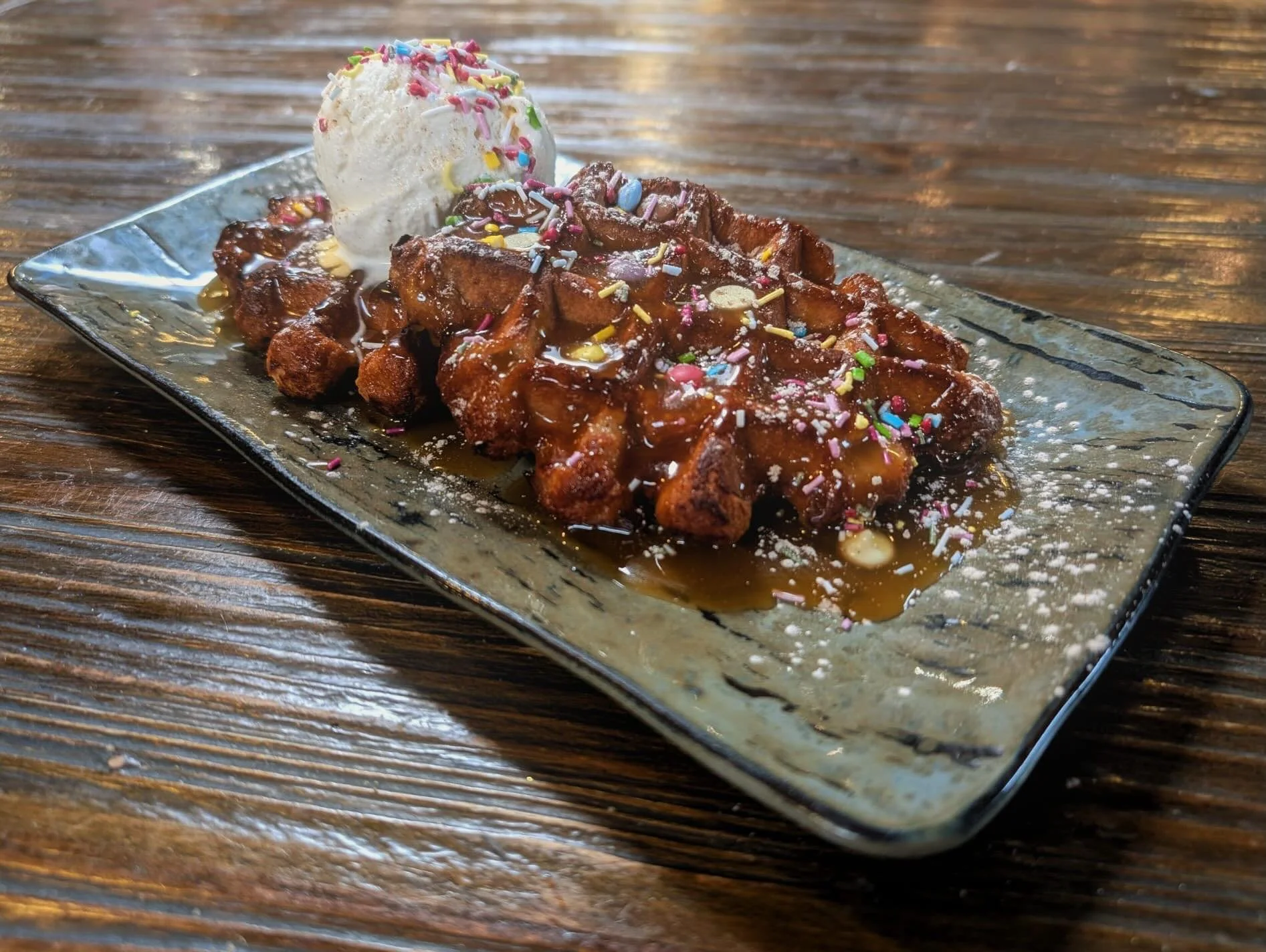 Belgian Waffles 🧇🇧🇪
Homemade Butterscotch Sauce 😍
Sprinkles 🥳 
Ice Cream 🍨 

Special and Sweet 🤤