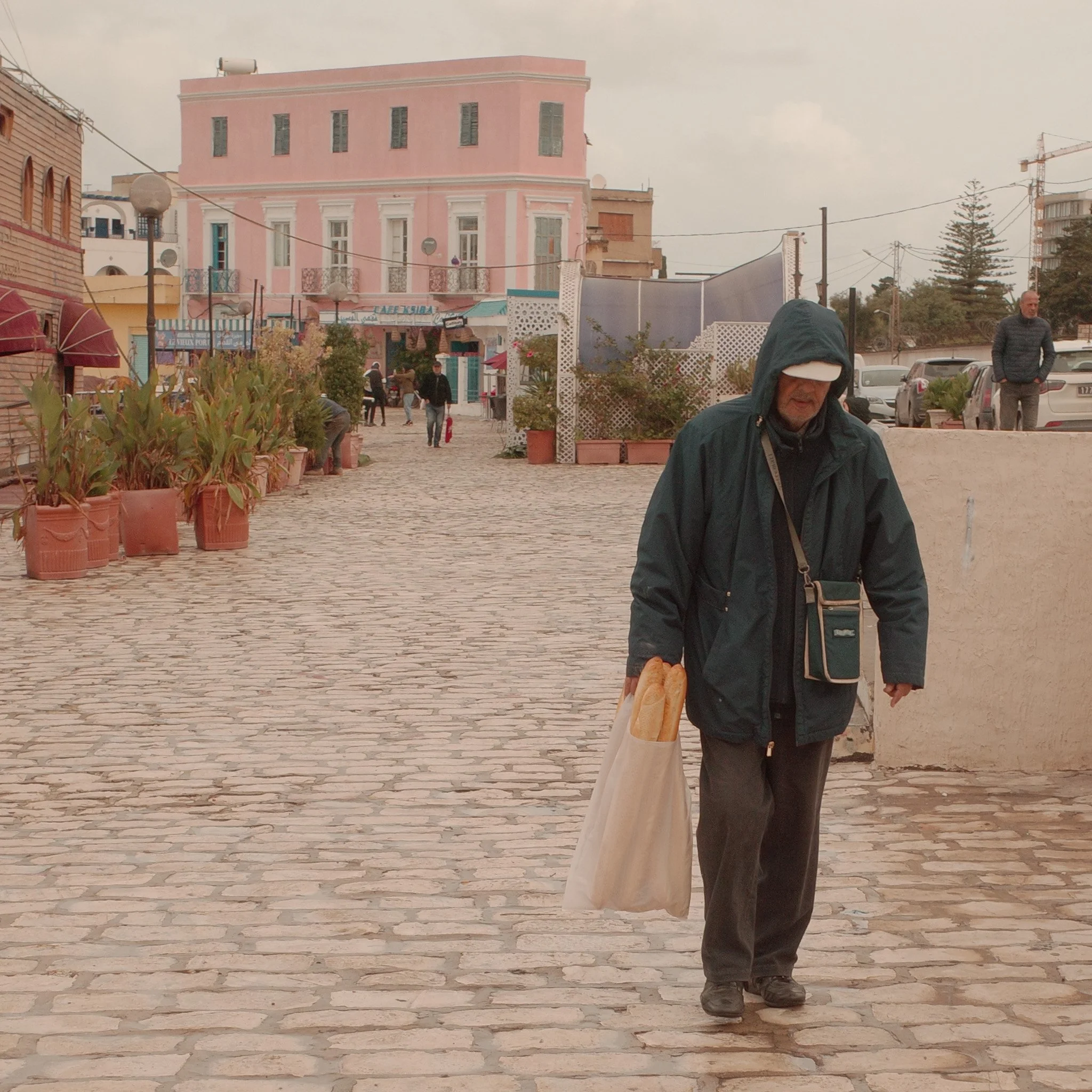 Man carrying Baguettes - Photographed with Ricoh GR III and Film Simulation