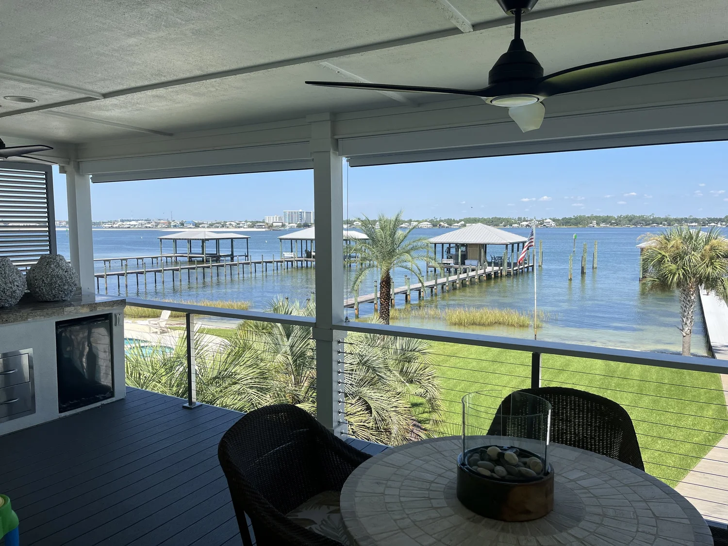 Exterior shades lowered on a waterfront covered patio while preserving the view