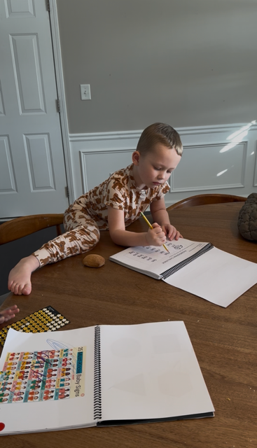 littles reading pic of tal working workbook.PNG
