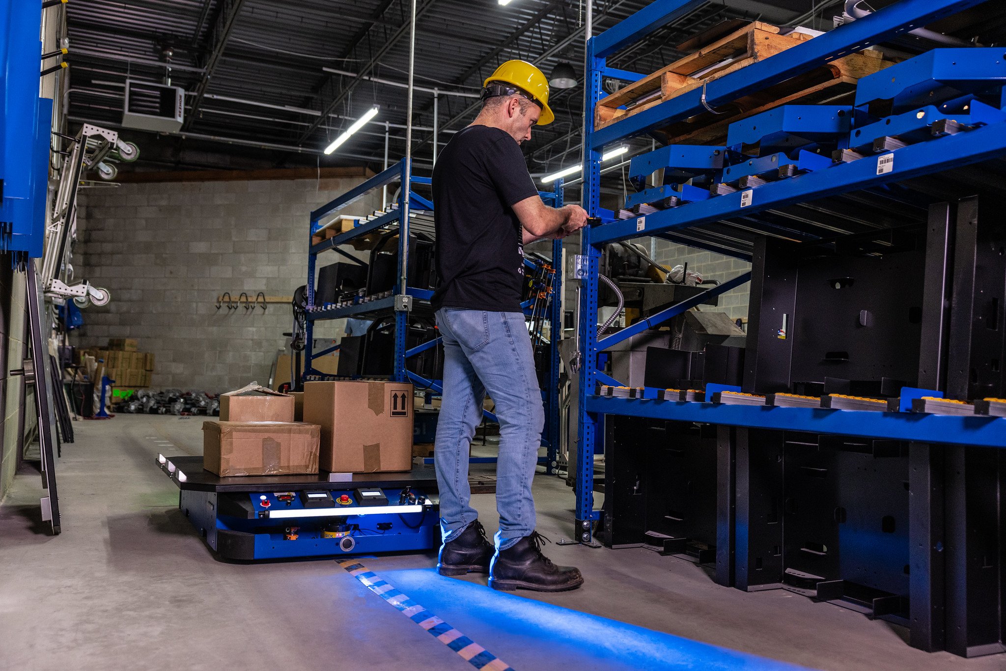 Barcoding Inc. worker in storage area with racking