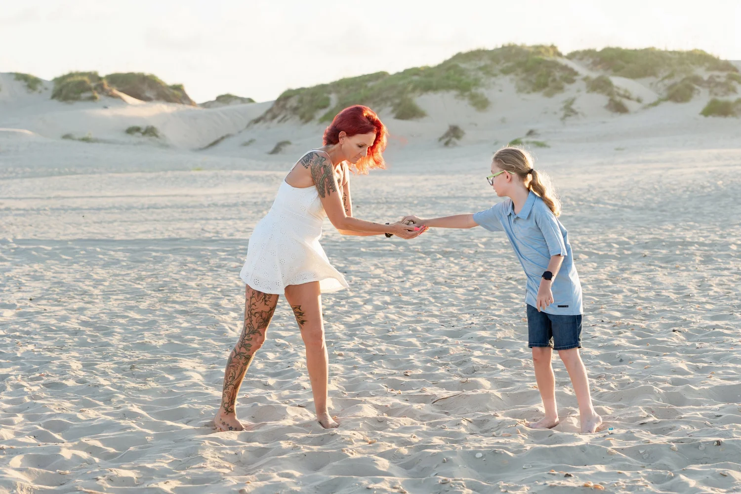 Mother and child sharing a candid moment in the South Padre Island sand dunes