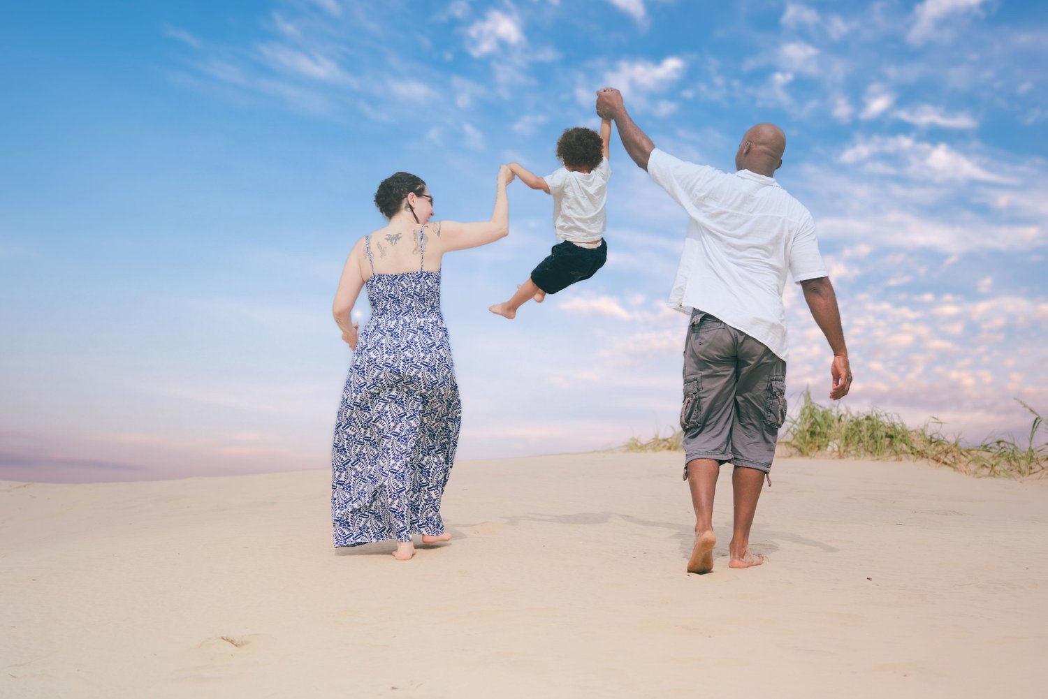 Parents playing with their child during a South Padre Island family photography session